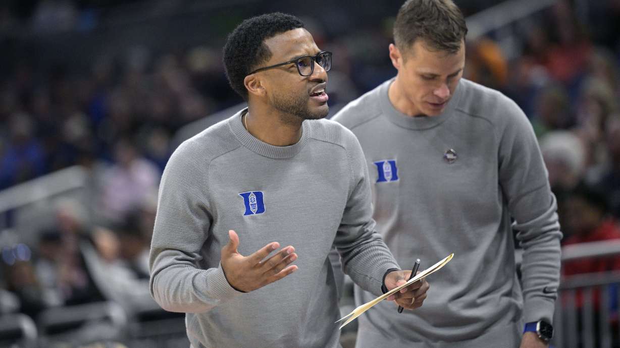 FILE - Duke assistant coach Jai Lucas, left, and head coach Jon Scheyer work during the first half of a first-round college basketball game against Oral Roberts in the NCAA Tournament, March 16, 2023, in Orlando, Fla.