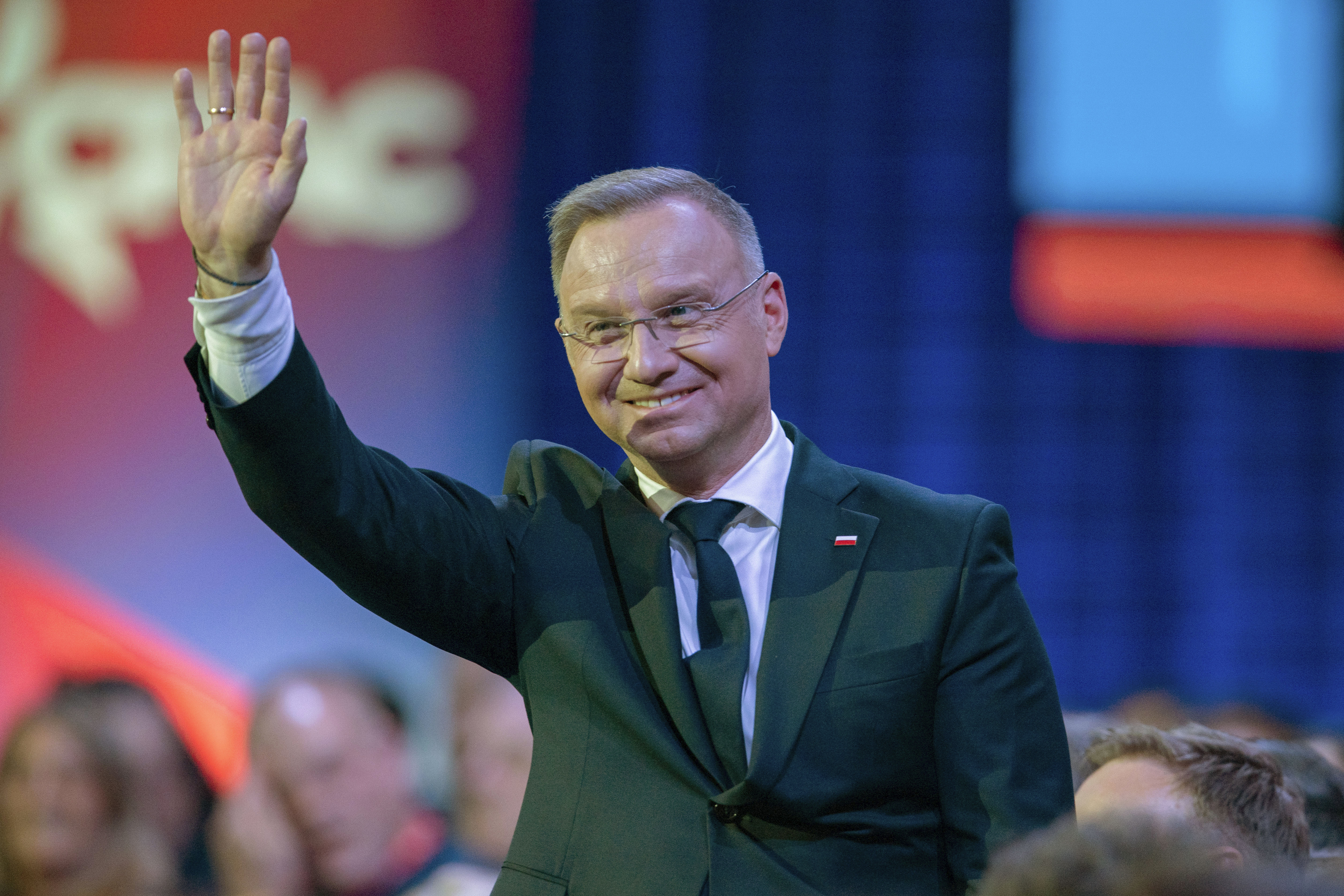 Polish President Andrzej Duda waves to President Donald Trump at the Conservative Political Action Conference, CPAC, at the Gaylord National Resort & Convention Center, Saturday in Oxon Hill, Md.