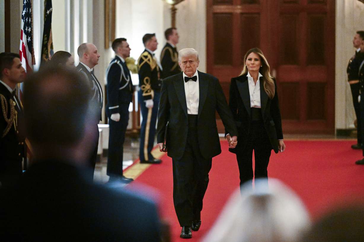 President Donald Trump and first lady Melania Trump arrive at the National Governors Association dinner and reception in the East Room of the White House, Saturday in Washington.