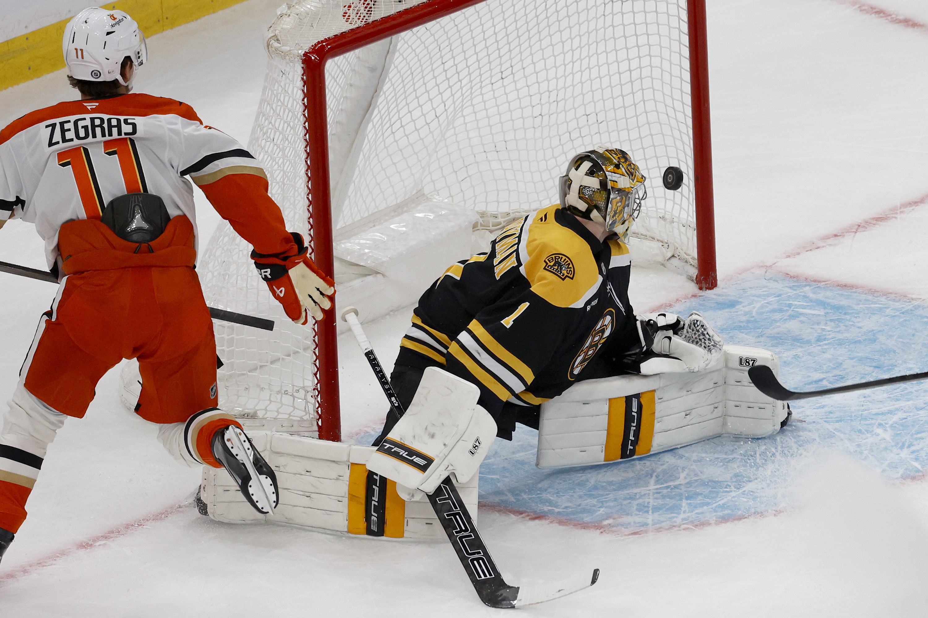 Anaheim Ducks center Trevor Zegras (11) scores past Boston Bruins goaltender Jeremy Swayman (1) during the first period of an NHL hockey game, Saturday, Feb. 22, 2025, in Boston.