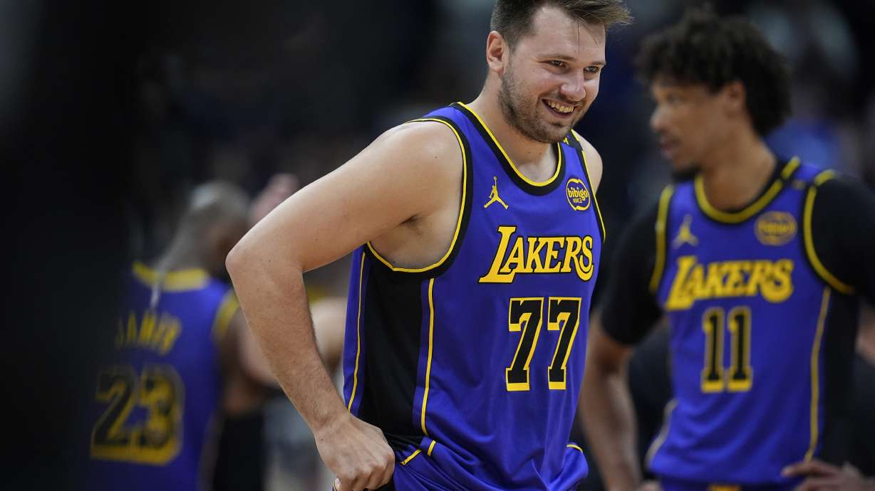 Los Angeles Lakers guard Luka Doncic laughs as he takes the court against the Denver Nuggets in the first half of an NBA basketball game Saturday, Feb. 22, 2025, in Denver.