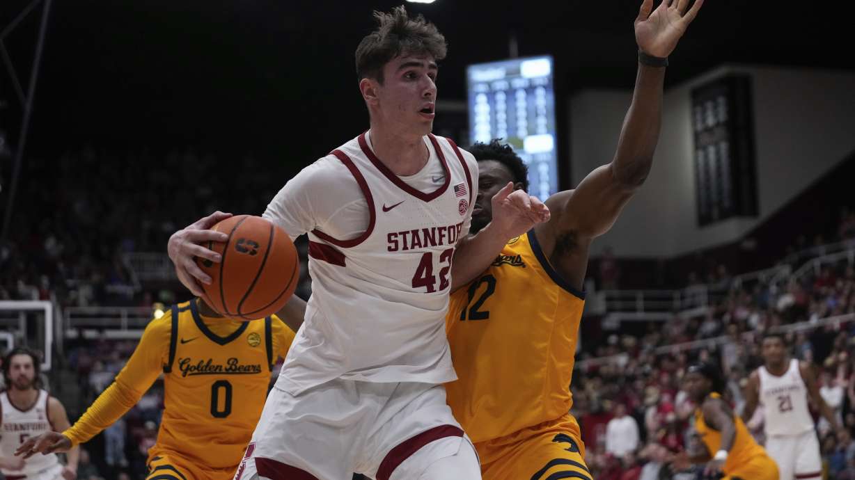 Stanford forward Maxime Raynaud, left, moves the ball while defended by California center Mady Sissoko, right, during the first half of an NCAA college basketball game Saturday, Feb. 22, 2025, in Stanford, Calif.