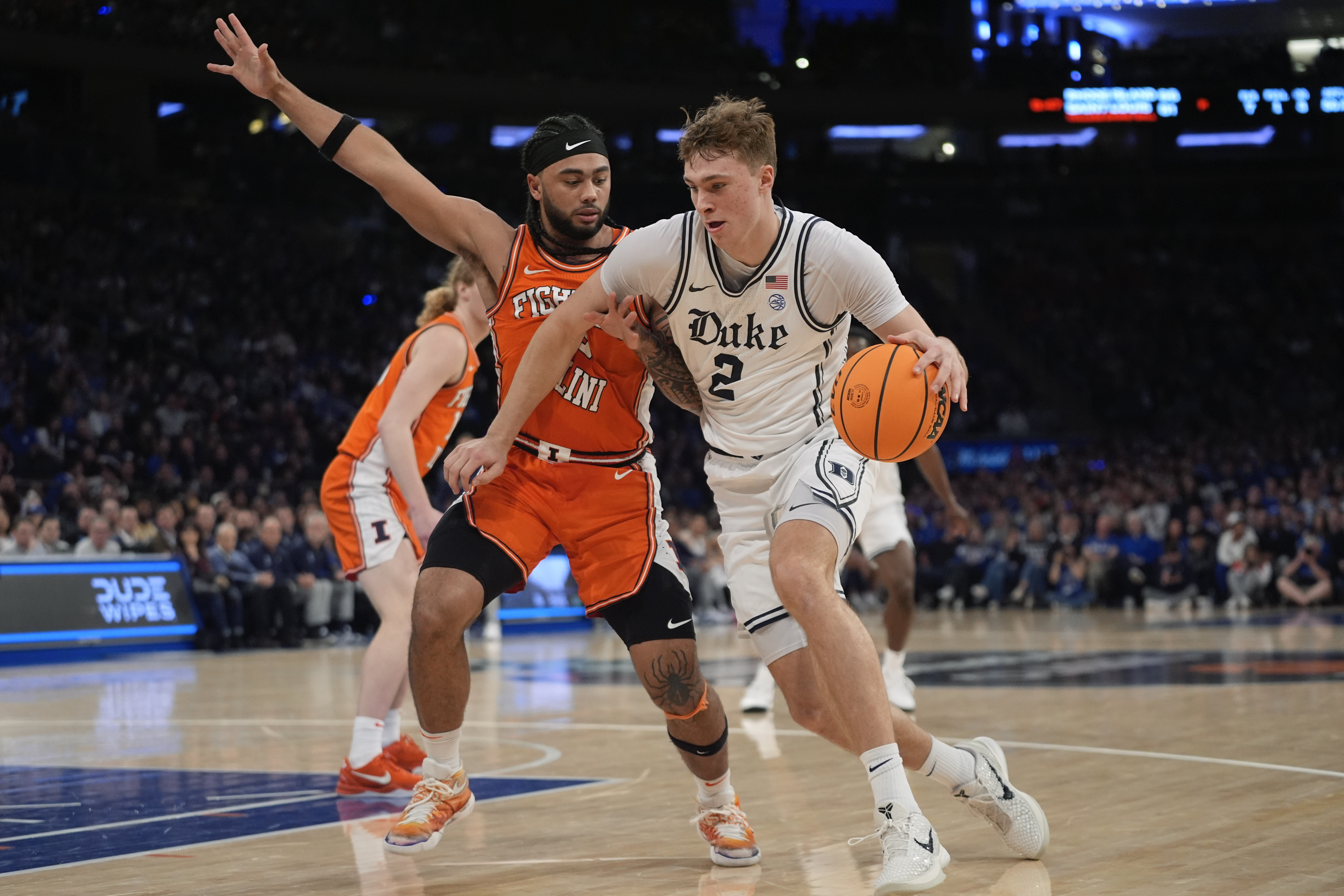 Duke's Cooper Flagg (2) drives past Illinois' Kylan Boswell (4) during the first half of an NCAA college basketball game Saturday, Feb. 22, 2025, in New York. 