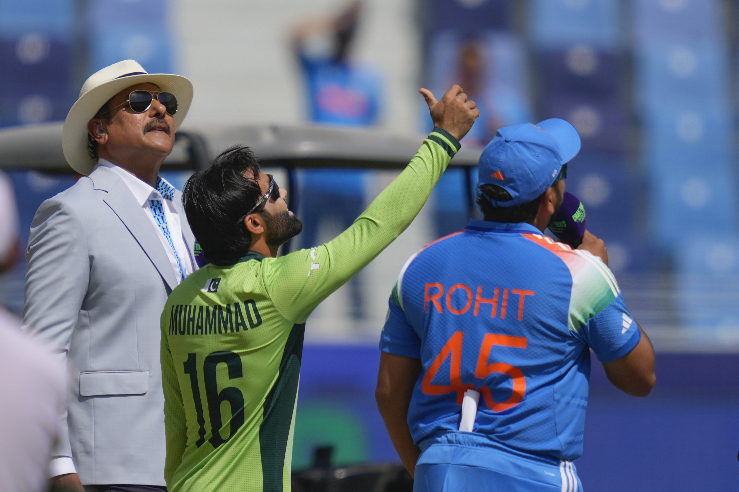 Pakistan's captain Mohammad Rizwan, centre, tosses the coin, as India's captain Rohit Sharma, right, looks on before the start of ICC Champions Trophy cricket match between India and Pakistan at Dubai International Cricket Stadium, United Arab Emirates, Sunday, Feb. 23, 2025. 