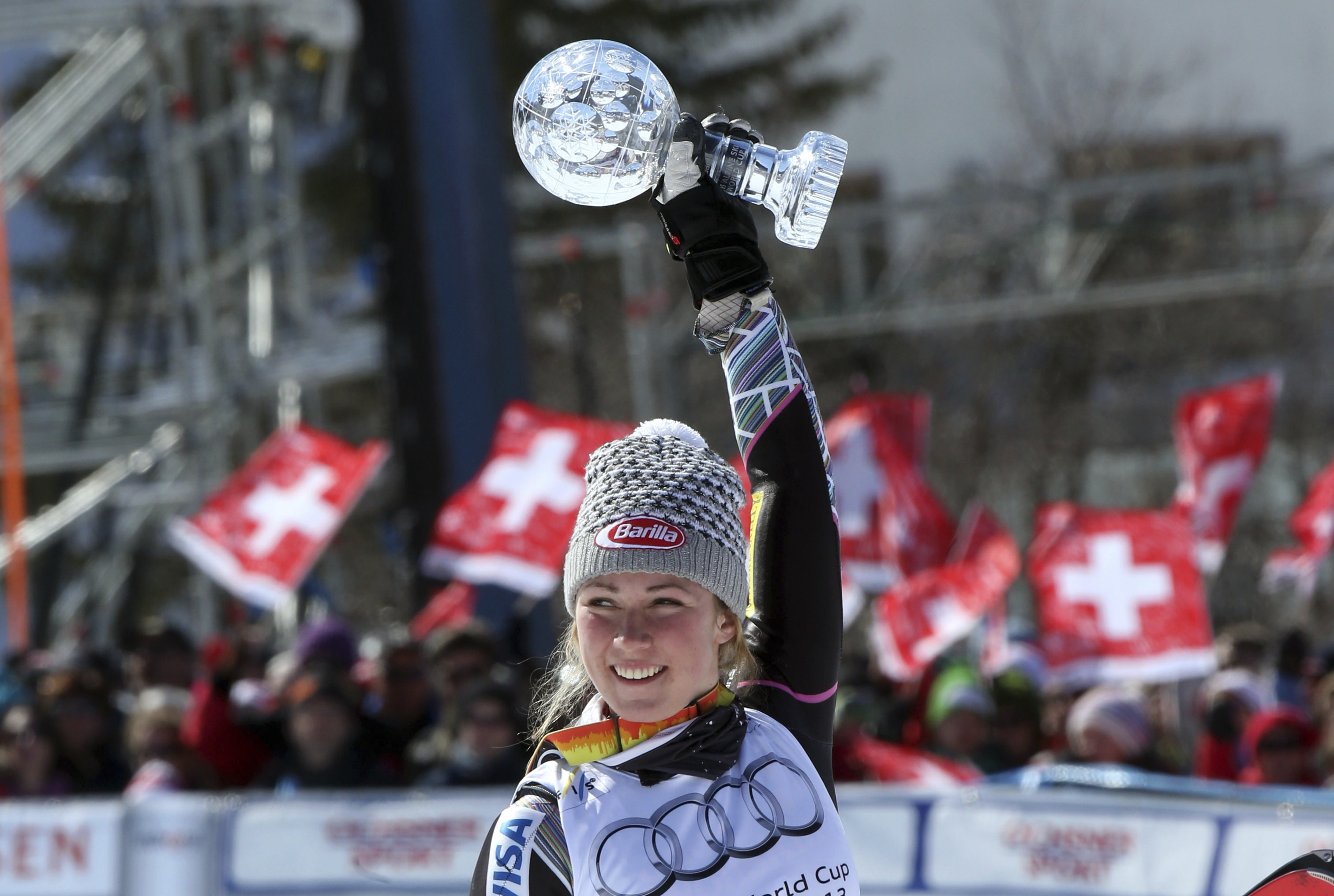 FILE - Mikaela Shiffrin from the United States holds up the women's slalom overall standing crystal globe during the Alpine Ski World Cup final in Lenzerheide, Switzerland, Saturday, March 16, 2013. 