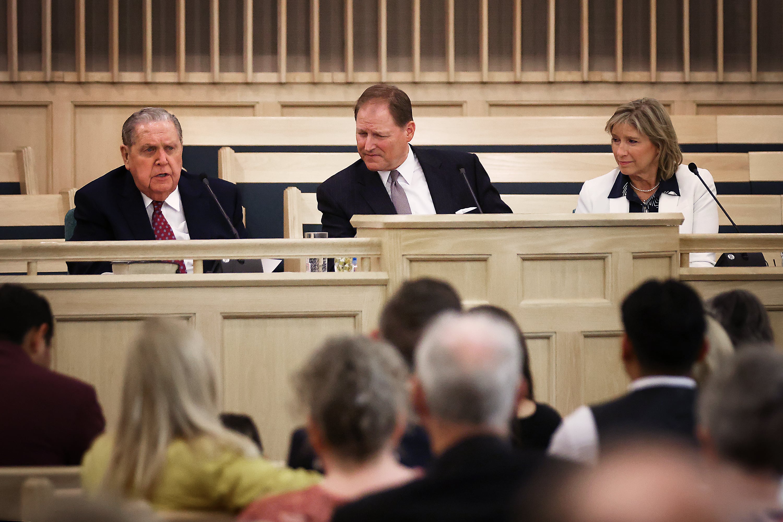 President Jeffrey R. Holland, acting president of the Quorum of the Twelve Apostles of The Church of Jesus Christ of Latter-day Saints, speaks as Elder Mark A. Bragg and Sister Yvonne Bragg listen along with hundreds of others gathered inside the San Fernando California Stake Center on Saturday in Van Nuys, Calif.