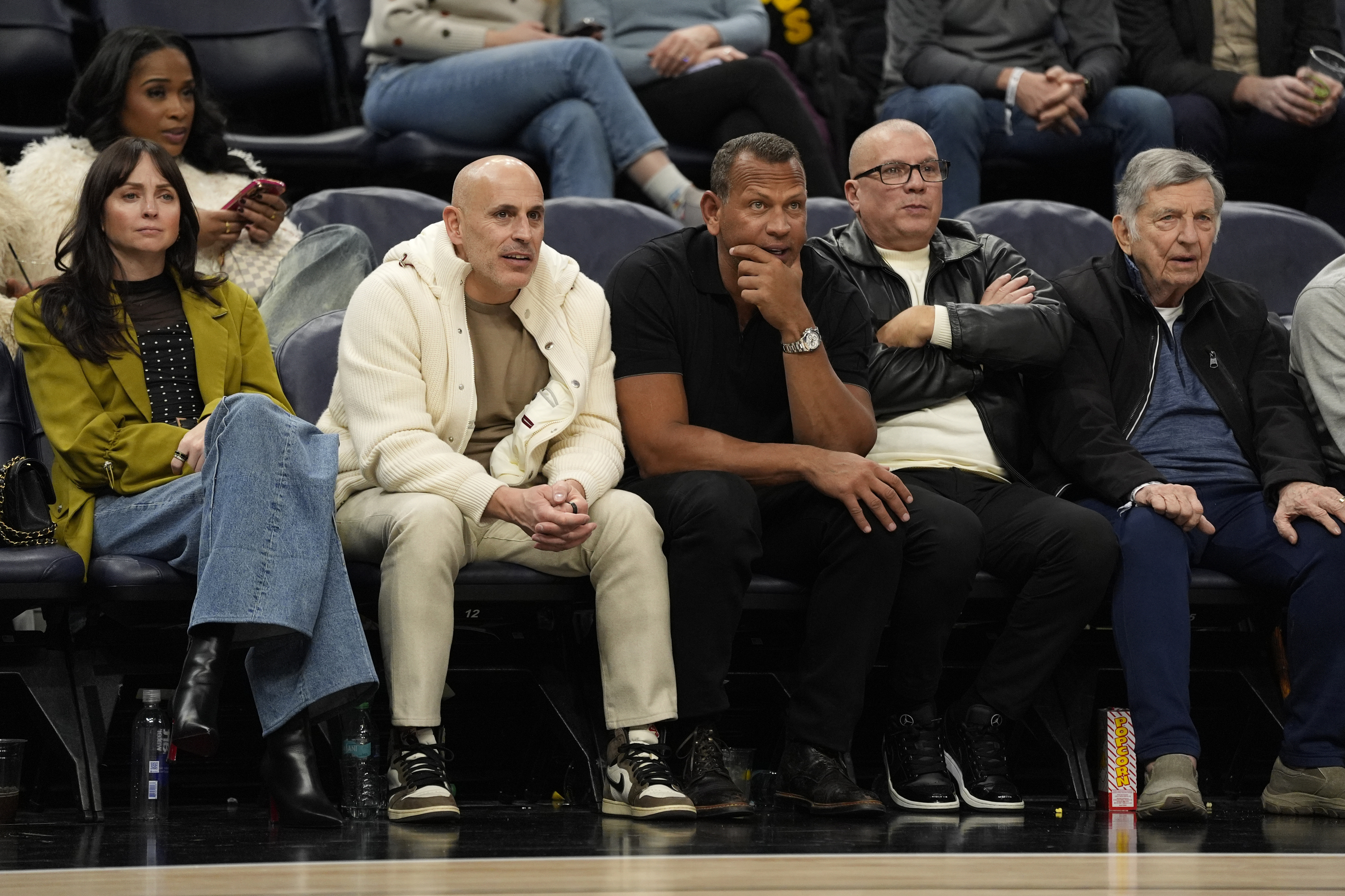FILE - Minnesota Timberwolves minority owners Marc Lore, middle left, and Alex Rodriguez, middle right, watch during the second half of an NBA basketball game against the New York Knicks Dec. 19, 2024, in Minneapolis. 