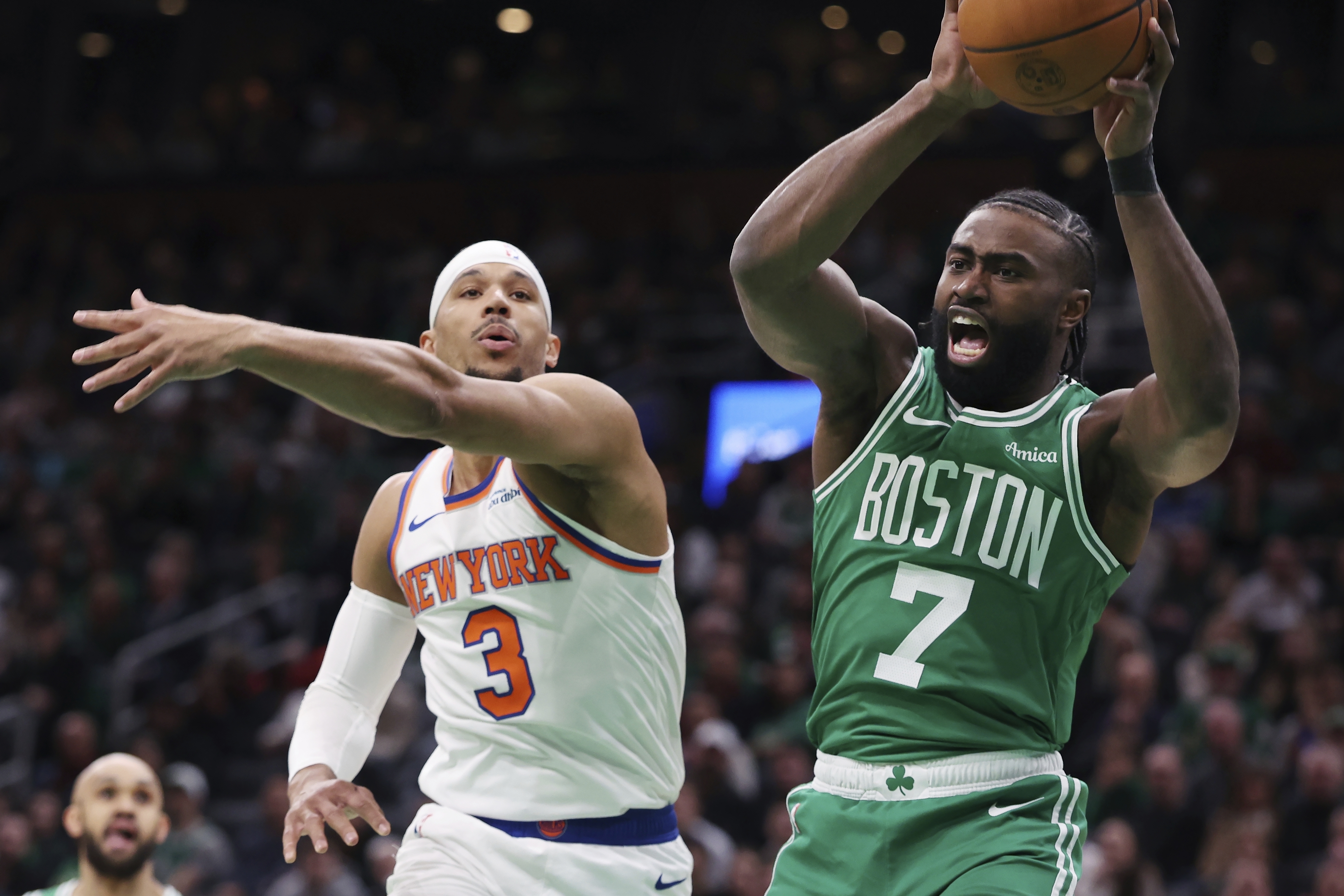 Boston Celtics' Jaylen Brown (7) grabs rebound against New York Knicks' Josh Hart (3) during the first half of an NBA basketball game Sunday, Feb. 23, 2025, in Boston. 