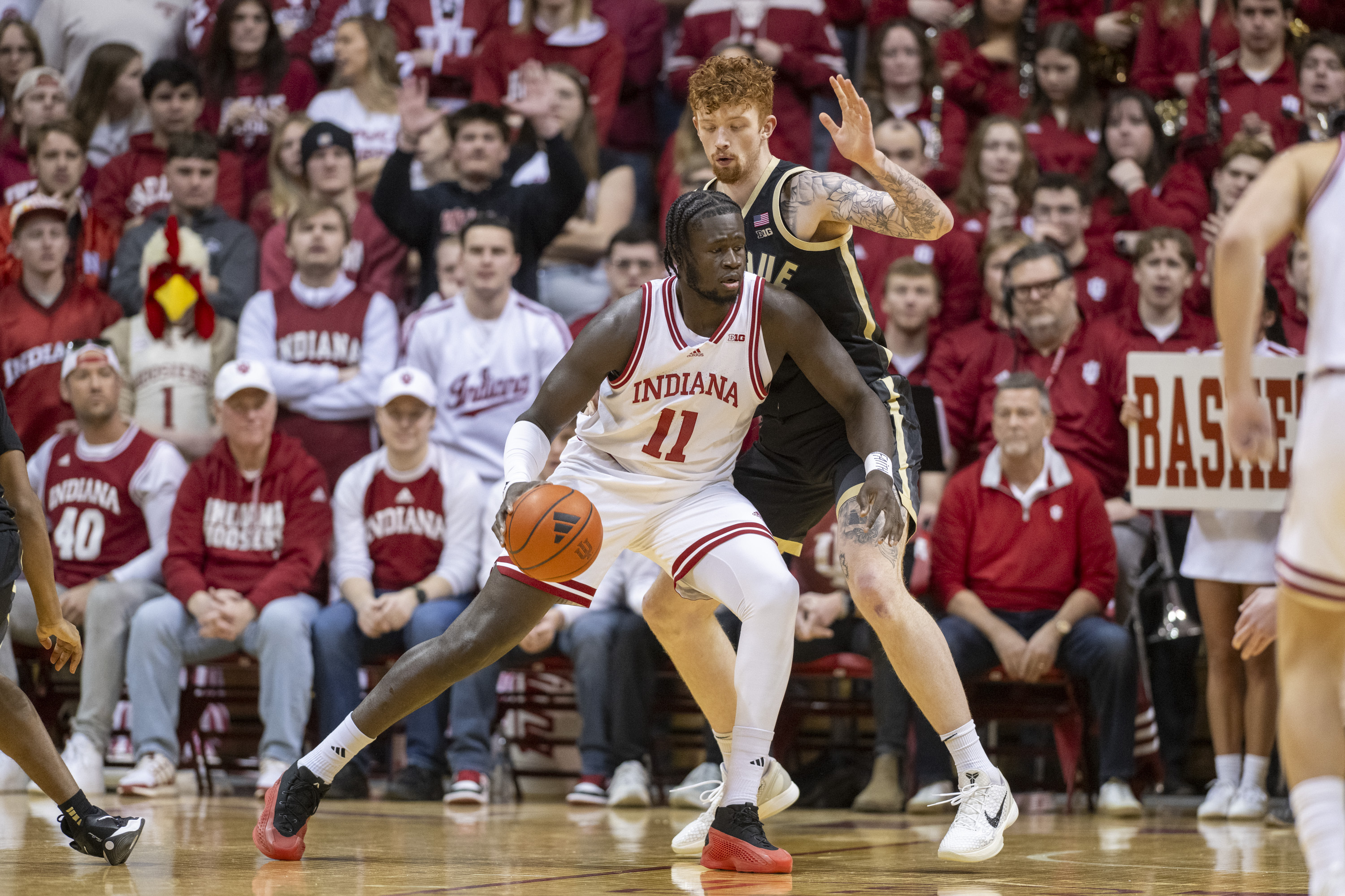 Indiana center Oumar Ballo (11) works the ball against the defense of Purdue center Will Berg (44) during the first half of an NCAA college basketball game, Sunday, Feb. 23, 2025, in Bloomington, Ind. 