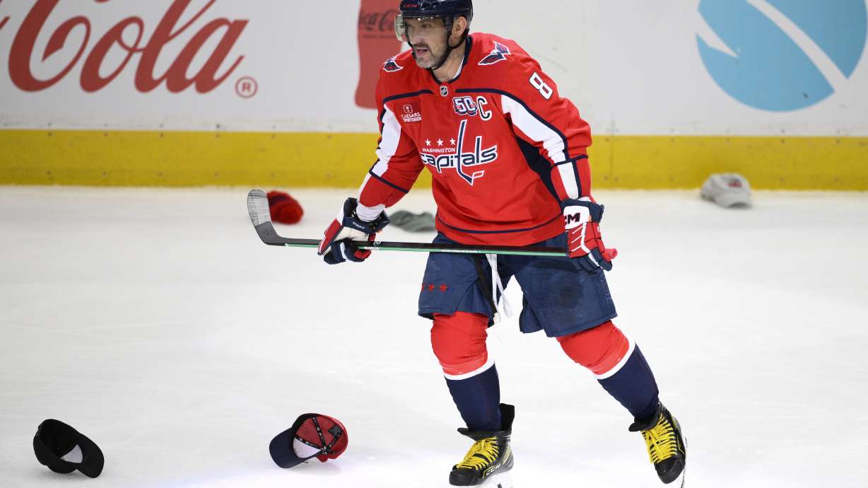Washington Capitals left wing Alex Ovechkin (8) skates among hats thrown onto the ice after he scored an empty-net goal for a hat trick during the third period of an NHL hockey game against the Edmonton Oilers, Sunday, Feb. 23, 2025, in Washington.