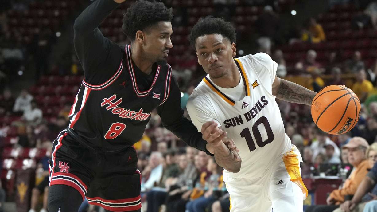 Arizona State guard BJ Freeman (10) drives on Houston guard Mylik Wilson during the second half of an NCAA college basketball game, Tuesday, Feb. 18, 2025, in Tempe, Ariz.