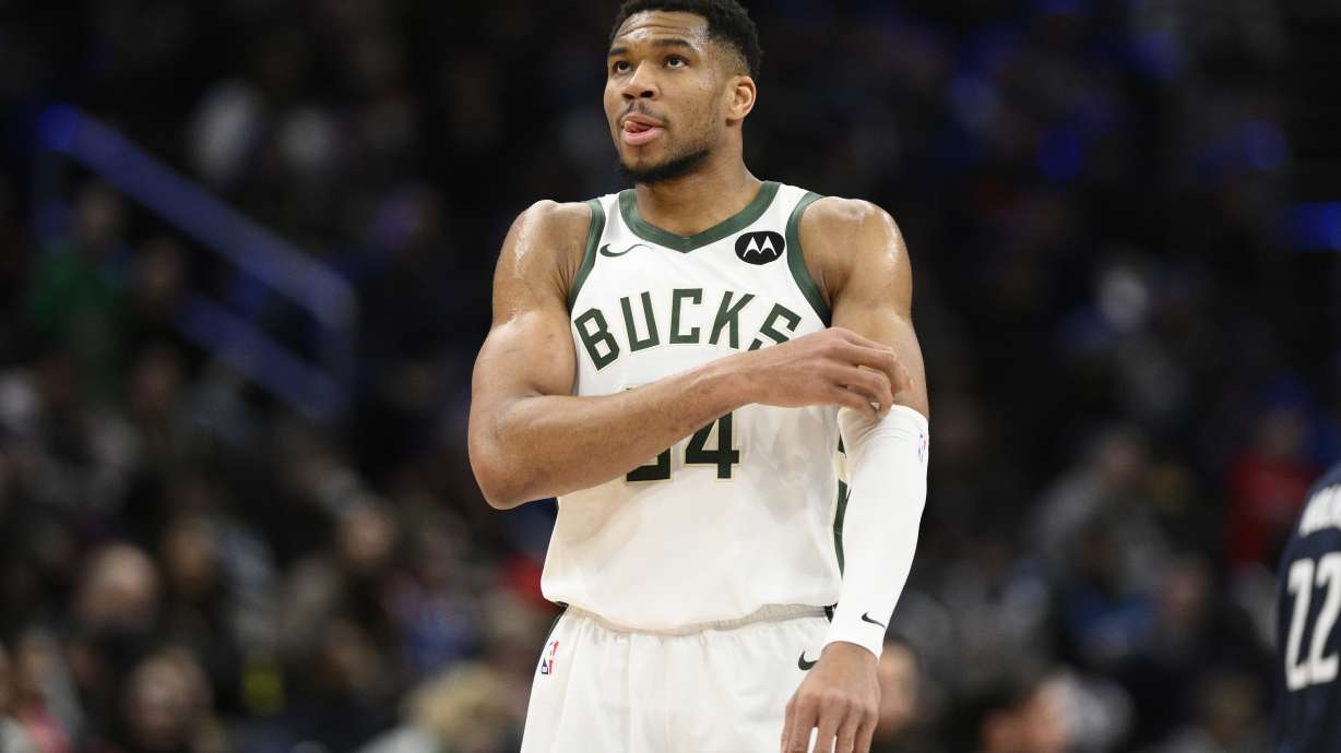 Milwaukee Bucks forward Giannis Antetokounmpo (34) adjusts his arm sleeve during the second half of an NBA basketball game against the Washington Wizards, Friday, Feb. 21, 2025, in Washington.