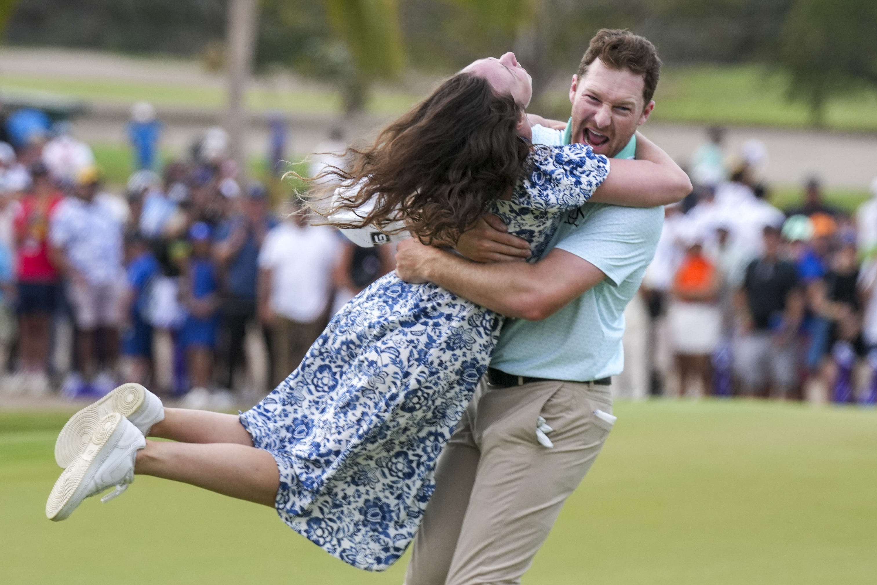 Brian Campbell, of the United States, embraces his girlfriend Kelsi McKee after winning the Mexico Open golf tournament in Puerto Vallarta, Mexico, Sunday, Feb. 23, 2025. 