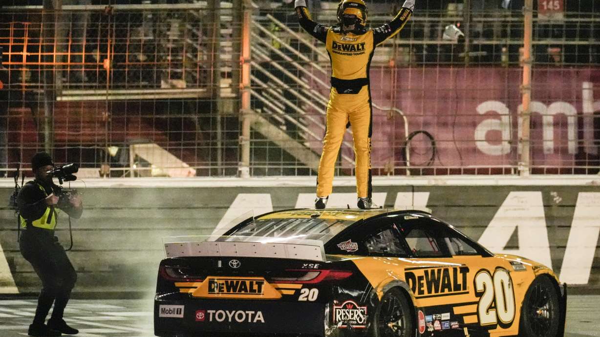 Christopher Bell (20) celebrates his victory after a NASCAR Cup Series auto race, Sunday, Feb. 23, 2025, in Hampton, Ga.