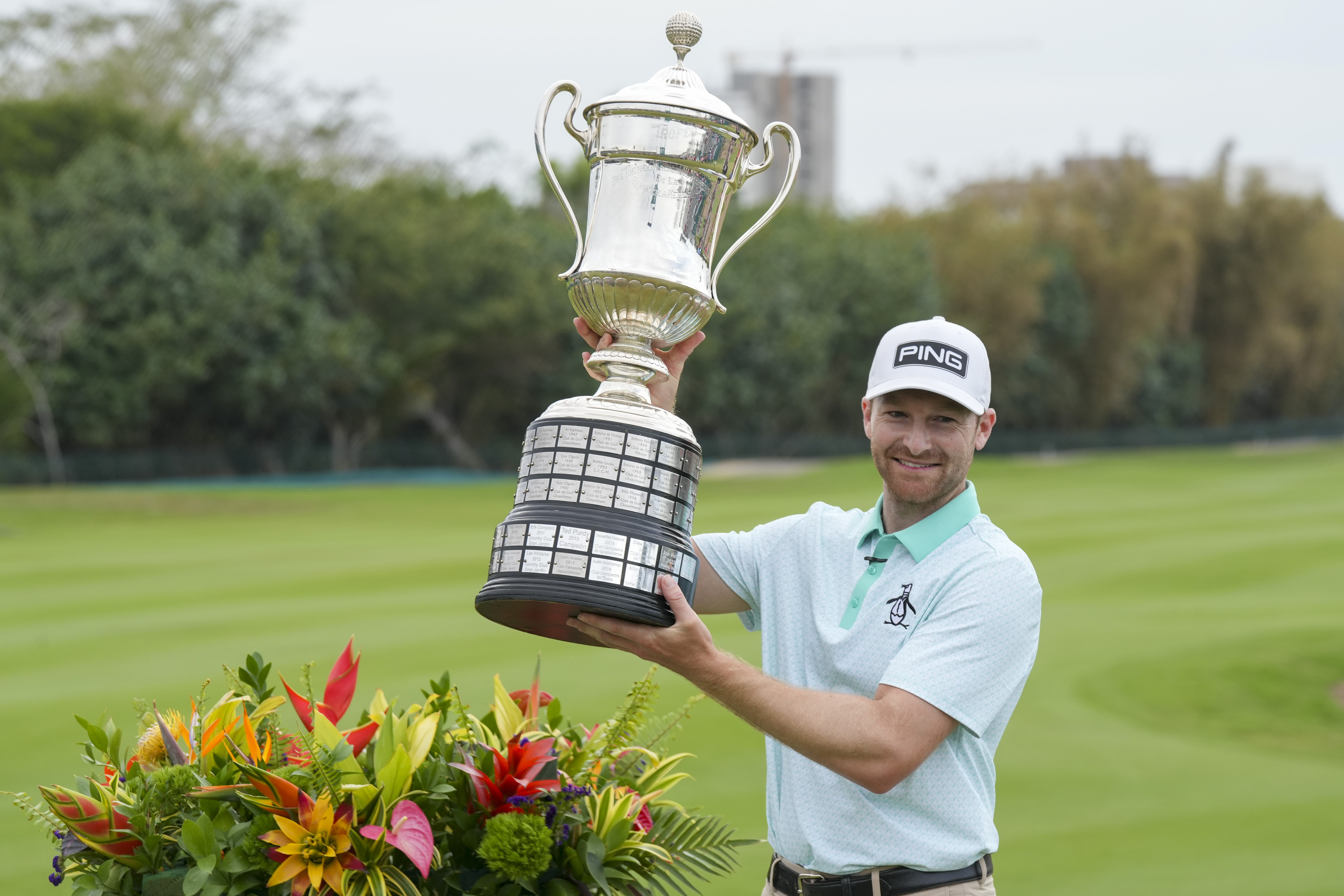 Brian Campbell, of the United States, holds the championship trophy after the final round of the Mexico Open golf tournament in Puerto Vallarta, Mexico, Sunday, Feb. 23, 2025. 