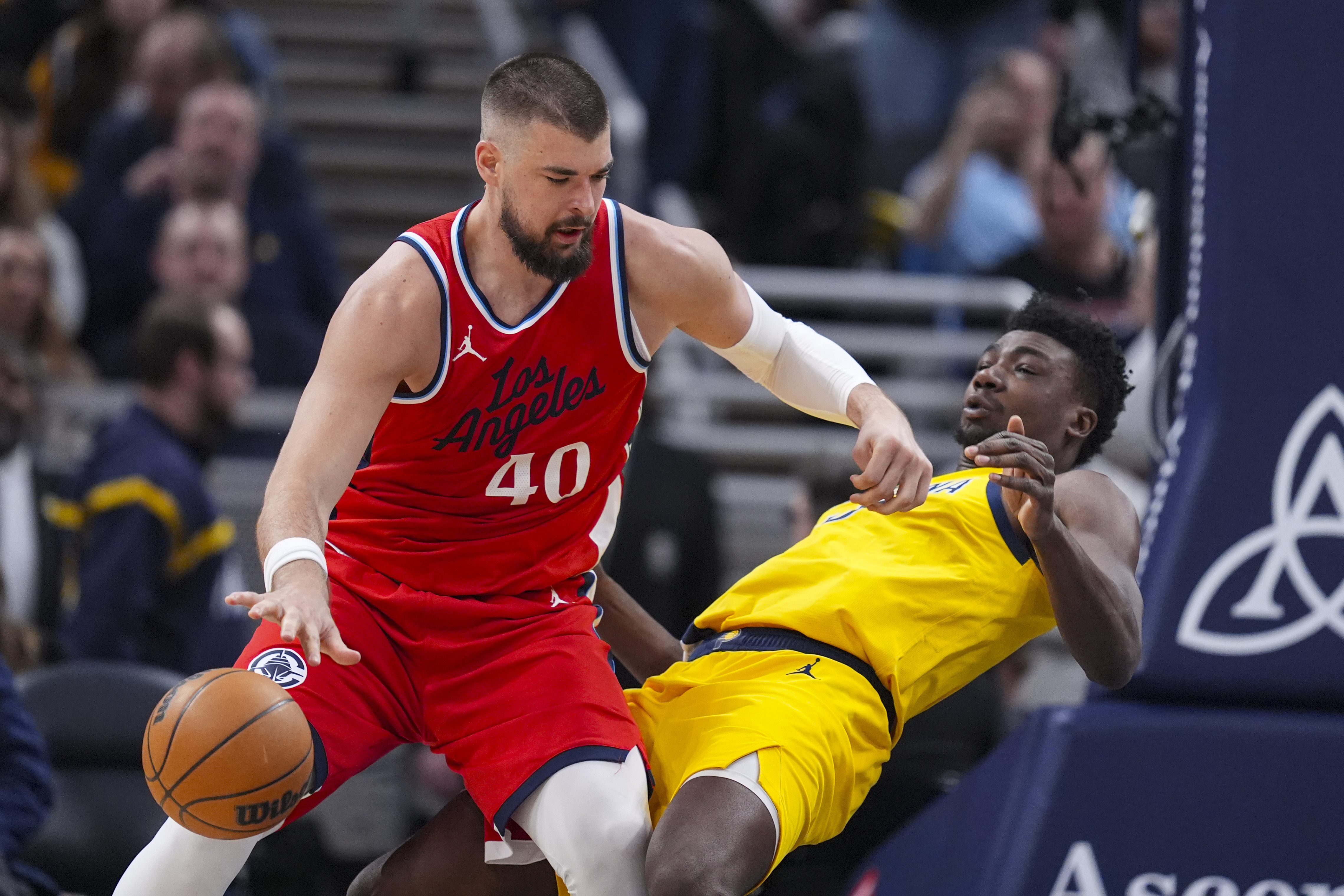 Indiana Pacers center Thomas Bryant (3) appears top draw the charge from LA Clippers center Ivica Zubac (40) during the first half of an NBA basketball game in Indianapolis, Sunday, Feb. 23, 2025. 