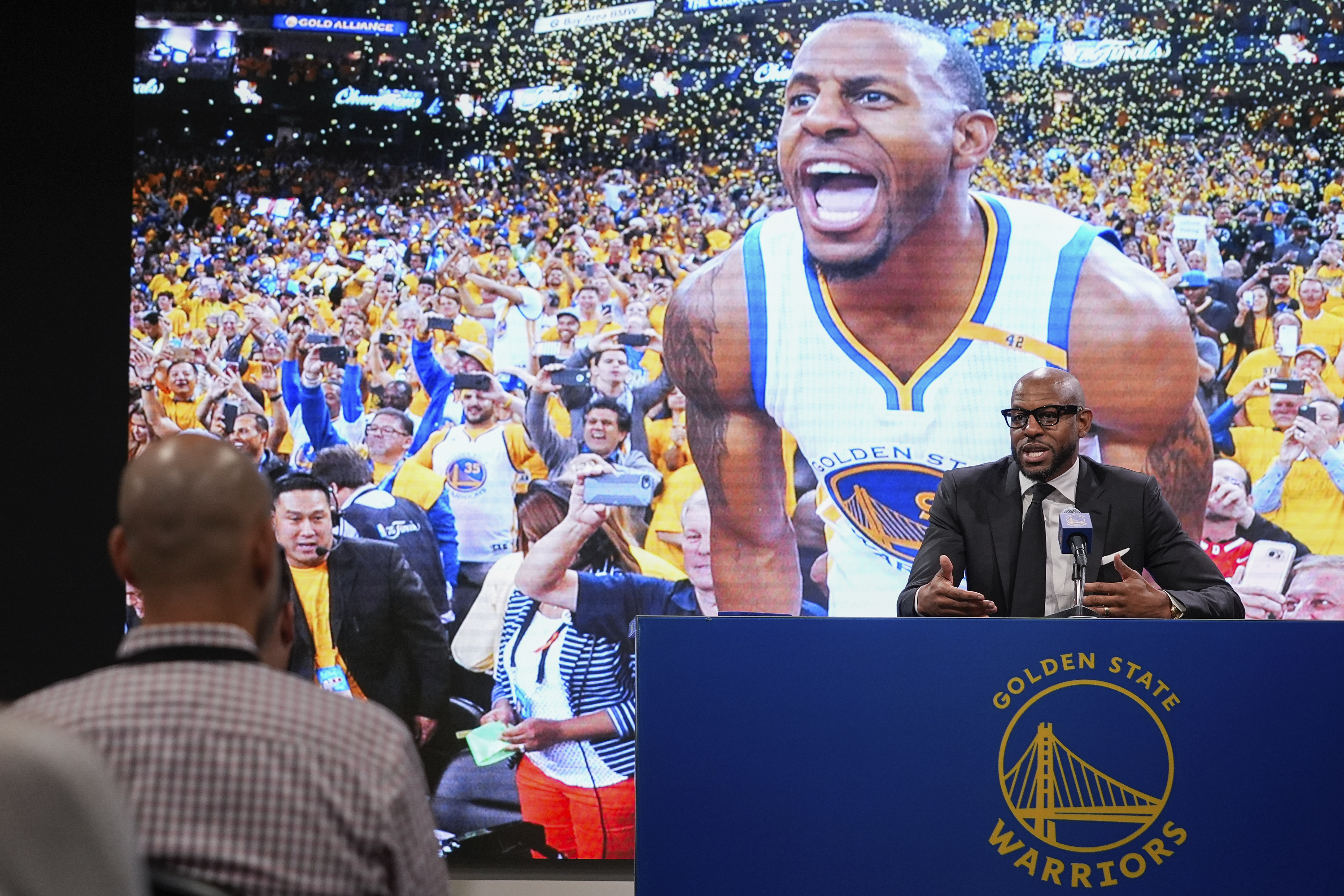 Former basketball player Andre Iguodala, right, talks to reporters before an NBA basketball game between the Golden State Warriors and the Dallas Mavericks, Sunday, Feb. 23, 2025, in San Francisco.