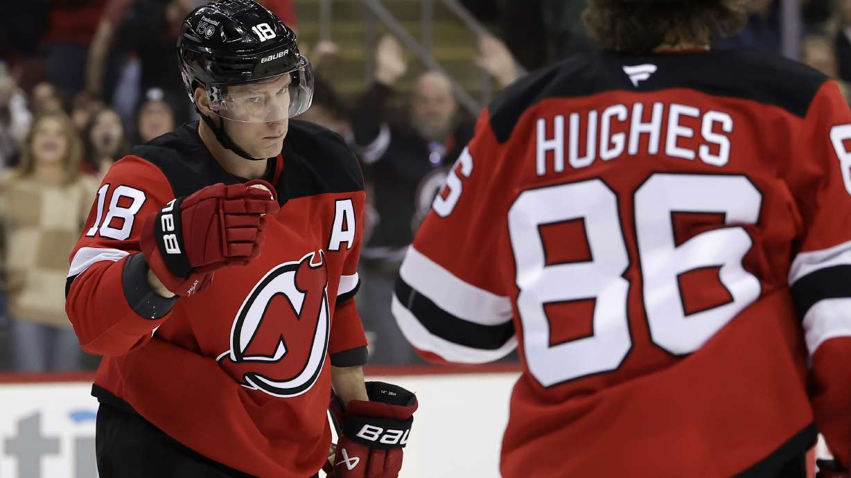 New Jersey Devils left wing Ondrej Palat (18) celebrates with Jack Hughes (86) after scoring a goal during the second period of an NHL hockey game against the Philadelphia Flyers, Wednesday, Jan. 29, 2025, in Newark, N.J.