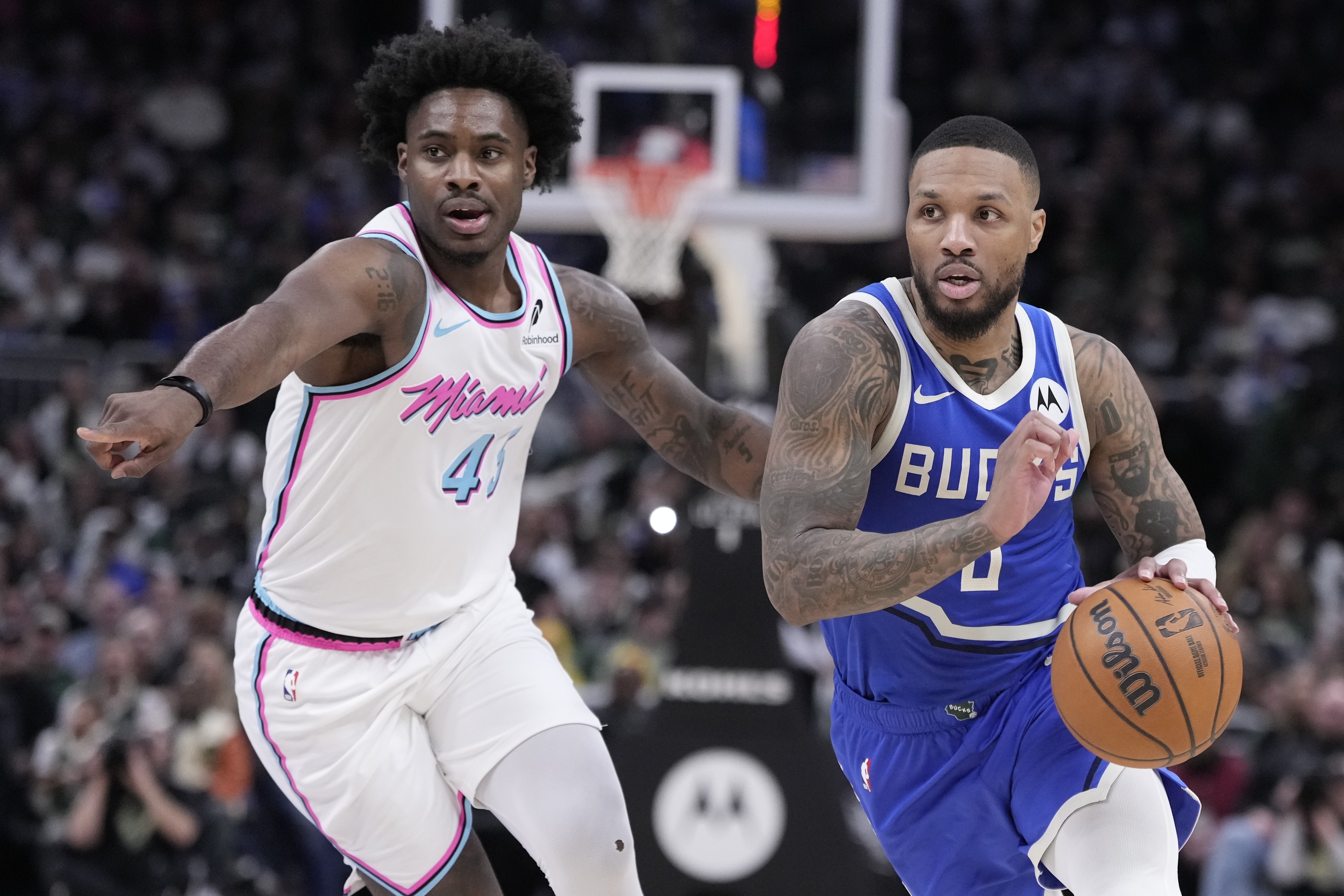Milwaukee Bucks' Damian Lillard drives past Miami Heat's Davion Mitchell during the second half of an NBA basketball game Sunday, Feb. 23, 2025, in Milwaukee. 