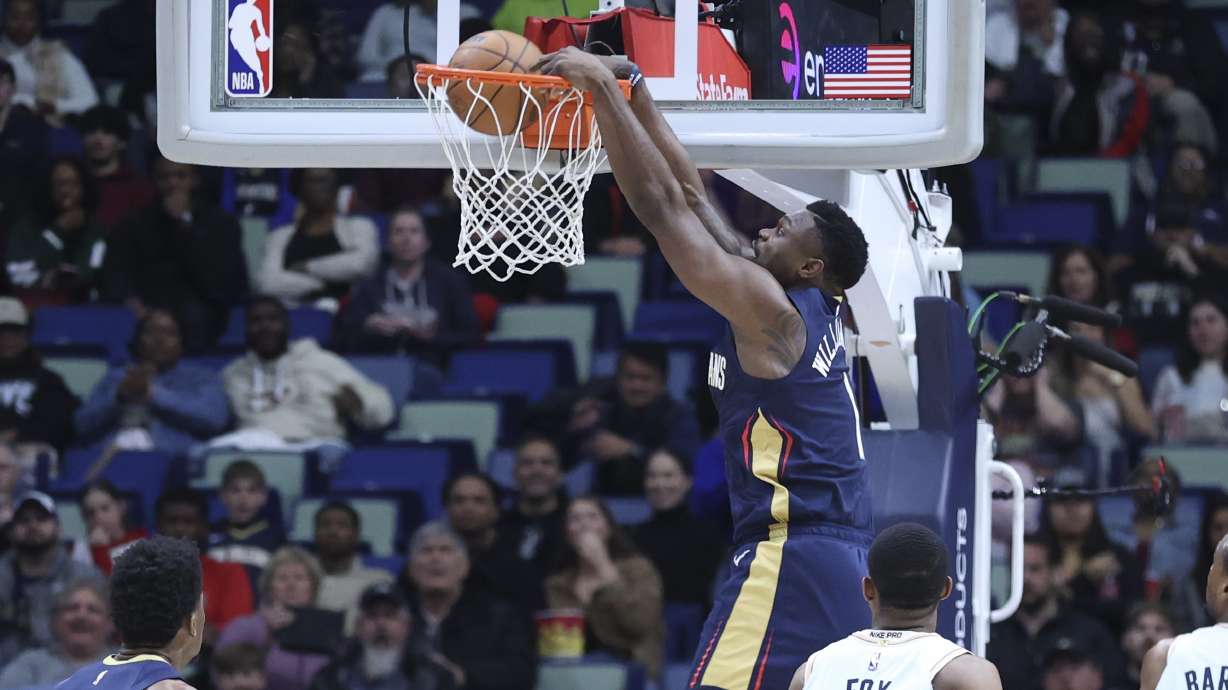 New Orleans Pelicans forward Zion Williamson (1) throws down a dunk in the first half of an NBA basketball game against the San Antonio Spurs in New Orleans, Sunday, Feb. 23, 2025.