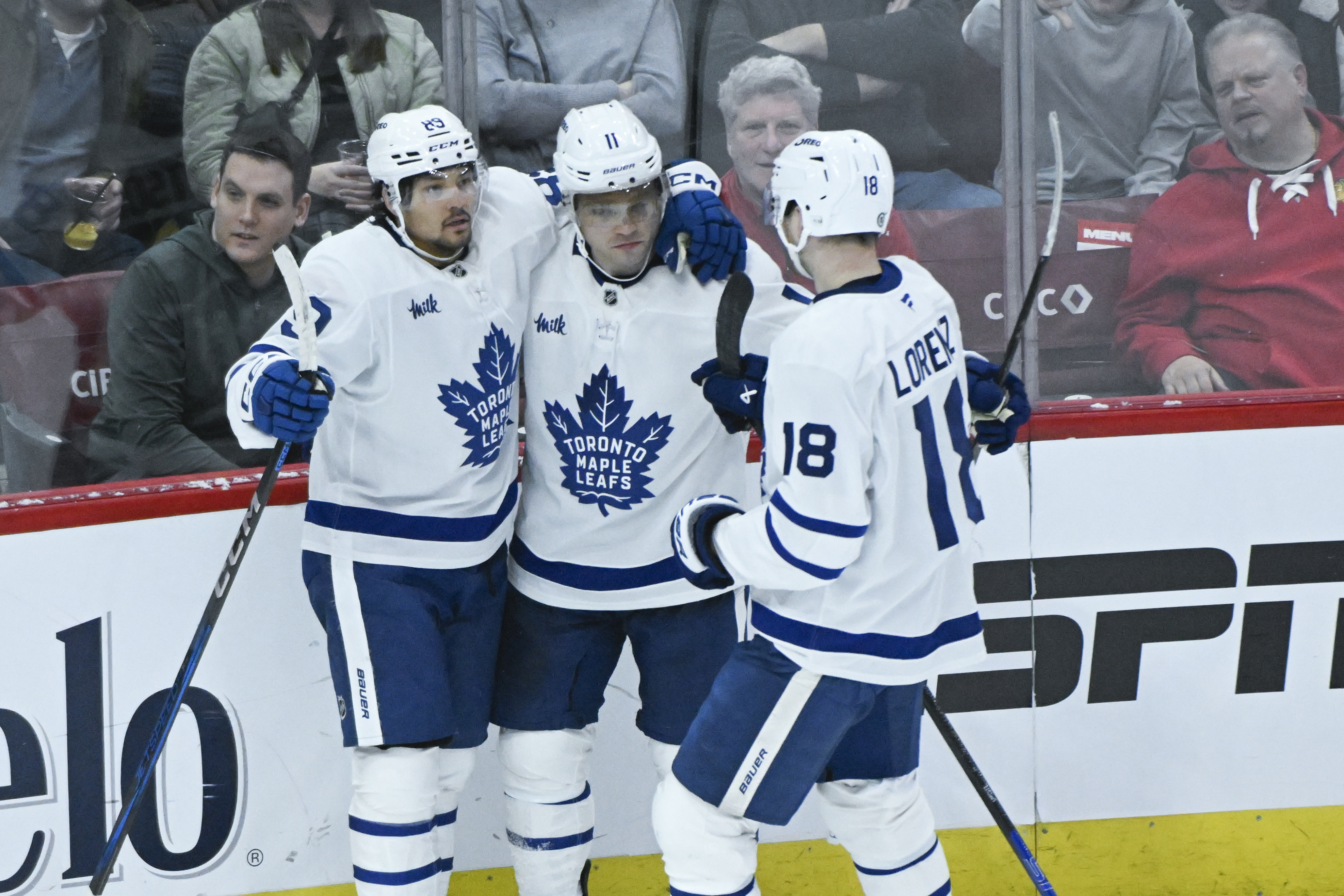 Toronto Maple Leafs left wing Nicholas Robertson celebrates with center Max Domi (11) and center Steven Lorentz (18) after he scores a goal against the Chicago Blackhawks during the second period of an NHL hockey game, Sunday, Feb. 23, 2025, in Chicago.