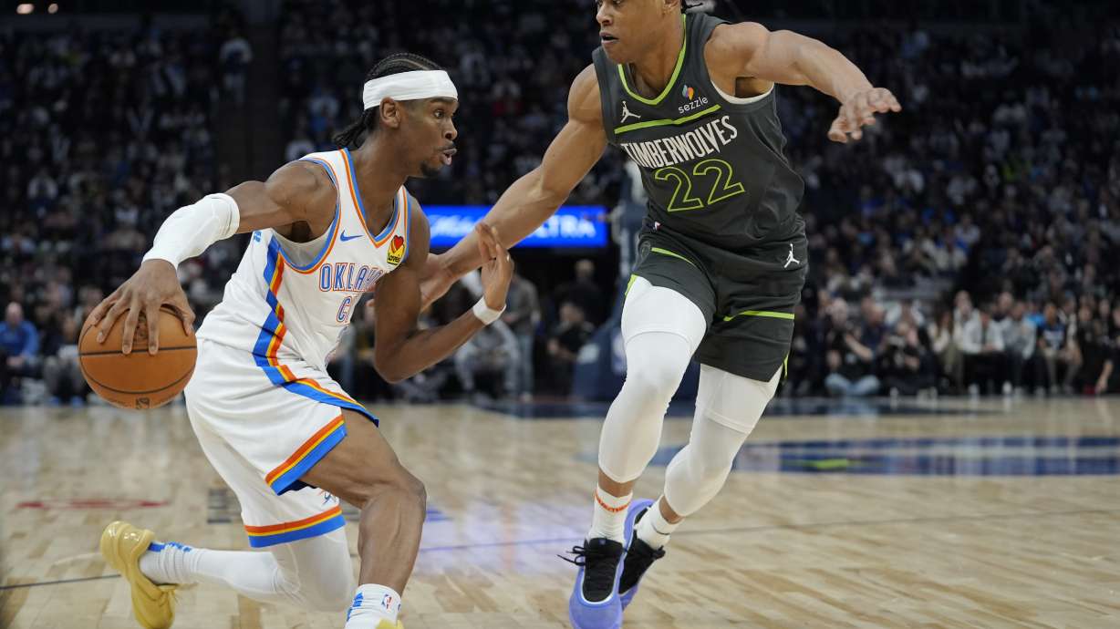 Oklahoma City Thunder guard Shai Gilgeous-Alexander (2) works toward the basket as Minnesota Timberwolves guard Jaylen Clark (22) defends during the second half of an NBA basketball game, Sunday, Feb. 23, 2025, in Minneapolis.