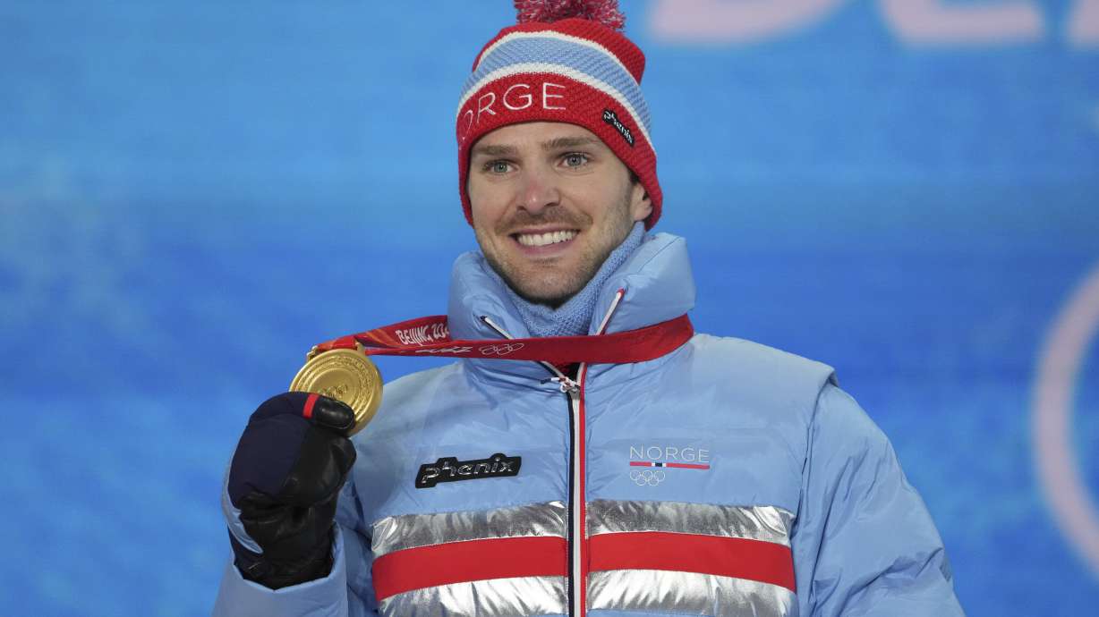 FILE - Gold medal winner Norway's Joergen Graabak shows his medal during the nordic combined individual Gunderson large hill/10k medal ceremony at the 2022 Winter Olympics, Wednesday, Feb. 16, 2022, in Zhangjiakou, China.