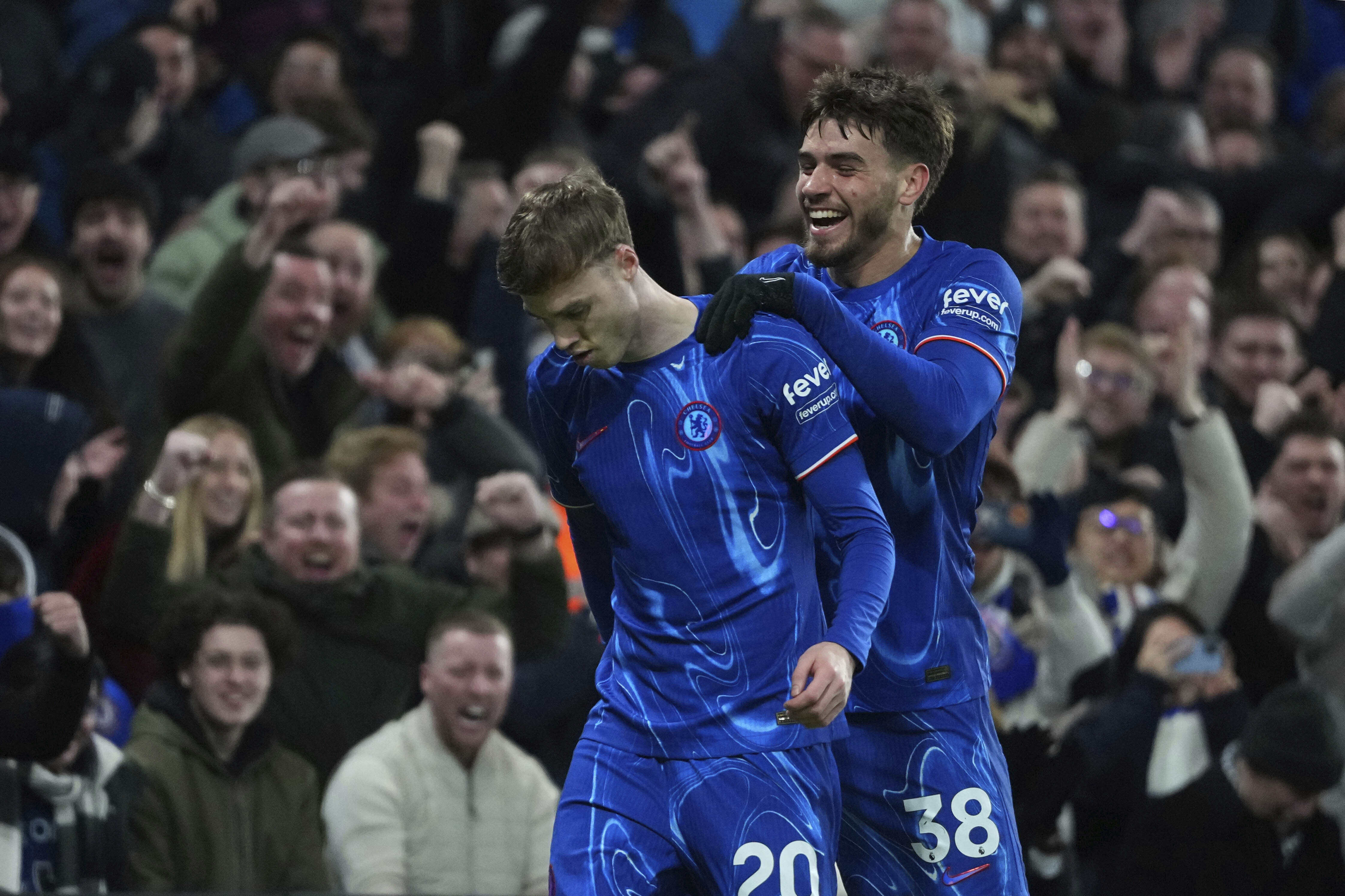 Chelsea's Cole Palmer, left, and Chelsea's Marc Guiu celebrate after an own goal by West Ham's Aaron Wan-Bissaka during the English Premier League soccer match between Chelsea and West Ham United at Stamford Bridge stadium in London, Monday, Feb. 3, 2025. 