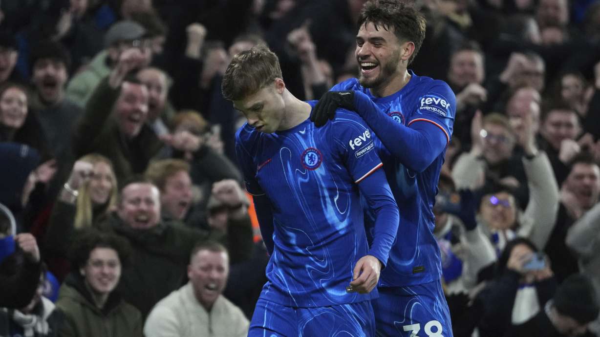 Chelsea's Cole Palmer, left, and Chelsea's Marc Guiu celebrate after an own goal by West Ham's Aaron Wan-Bissaka during the English Premier League soccer match between Chelsea and West Ham United at Stamford Bridge stadium in London, Monday, Feb. 3, 2025.