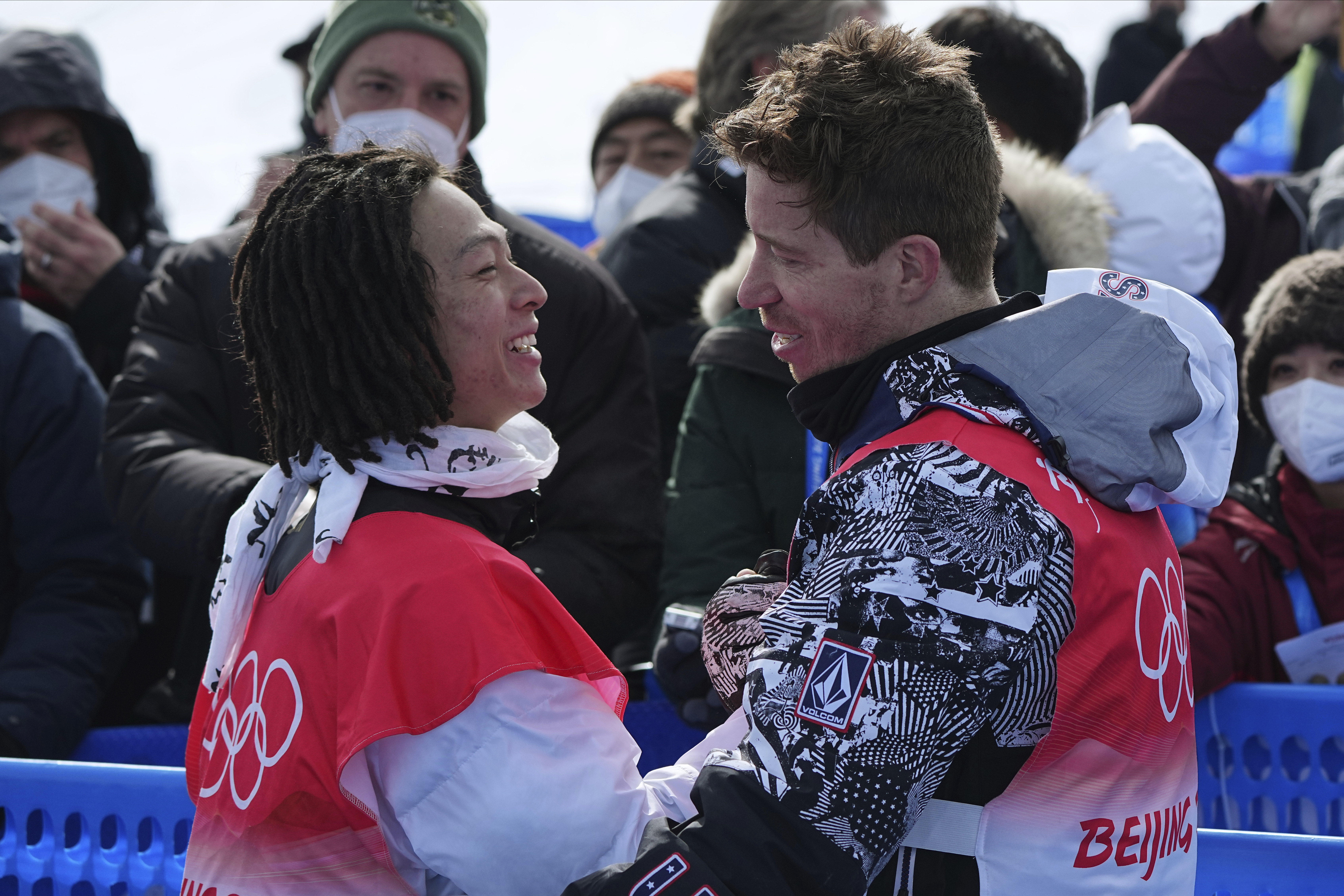 FILE - Gold medal winner Japan's Ayumu Hirano, left, is congratulated by United States' Shaun White after the men's halfpipe finals at the 2022 Winter Olympics, Feb. 11, 2022, in Zhangjiakou, China.
