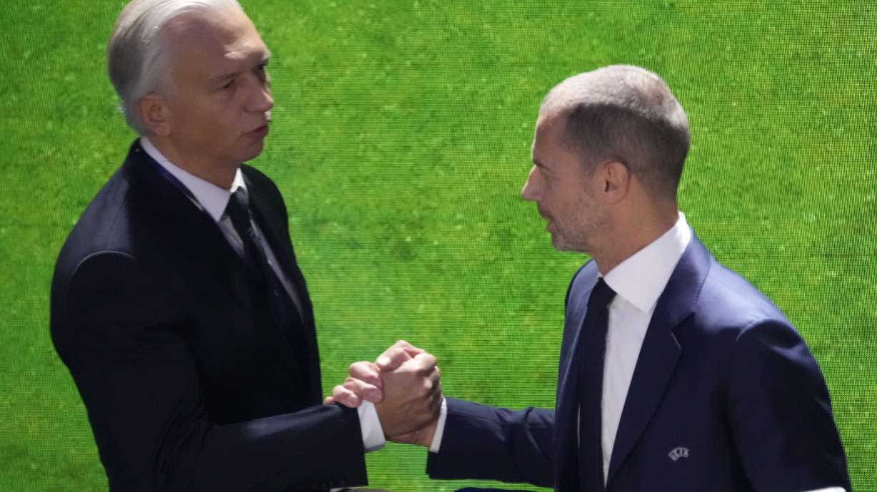 FILE - UEFA President Aleksander Ceferin, right, shakes hands with member of executive committee Alexander Dyukov during the 48th UEFA congress, Feb. 8, 2024 in Paris.