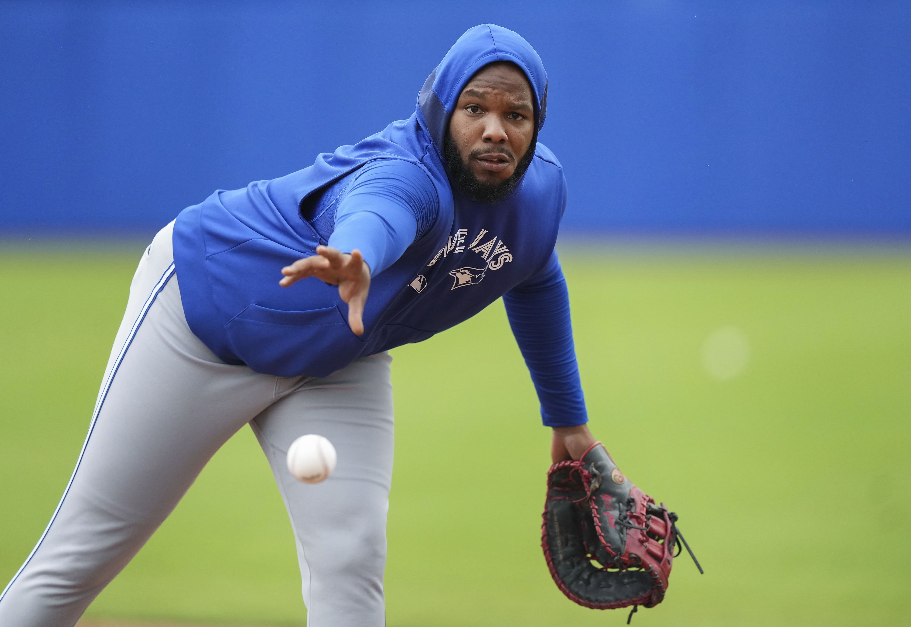 Toronto Blue Jays first baseman Vladimir Guerrero Jr. throws the ball to first base during spring training baseball workouts in Dunedin Fla., Thursday, Feb. 20, 2025. 