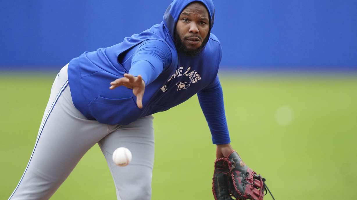 Toronto Blue Jays first baseman Vladimir Guerrero Jr. throws the ball to first base during spring training baseball workouts in Dunedin Fla., Thursday, Feb. 20, 2025.
