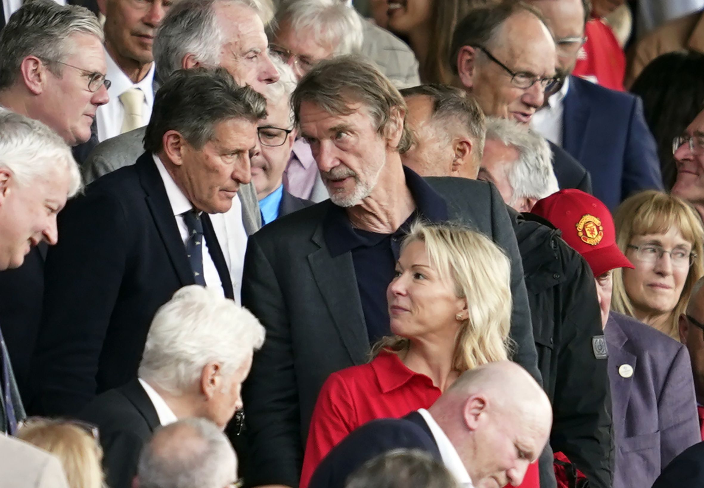 FILE - Jim Ratcliffe, center, in the stands during the English Premier League soccer match between Manchester United and Arsenal at the Old Trafford Stadium in Manchester, England, Sunday, May 12, 2024. 