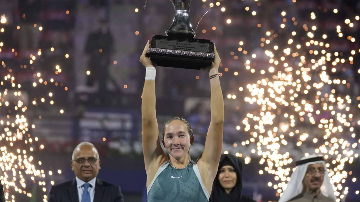 Russia's Mirra Andreeva holds the winner's trophy after the Dubai Duty Free Tennis Championship final match in Dubai, United Arab Emirates, on Saturday, Feb. 22, 2025.