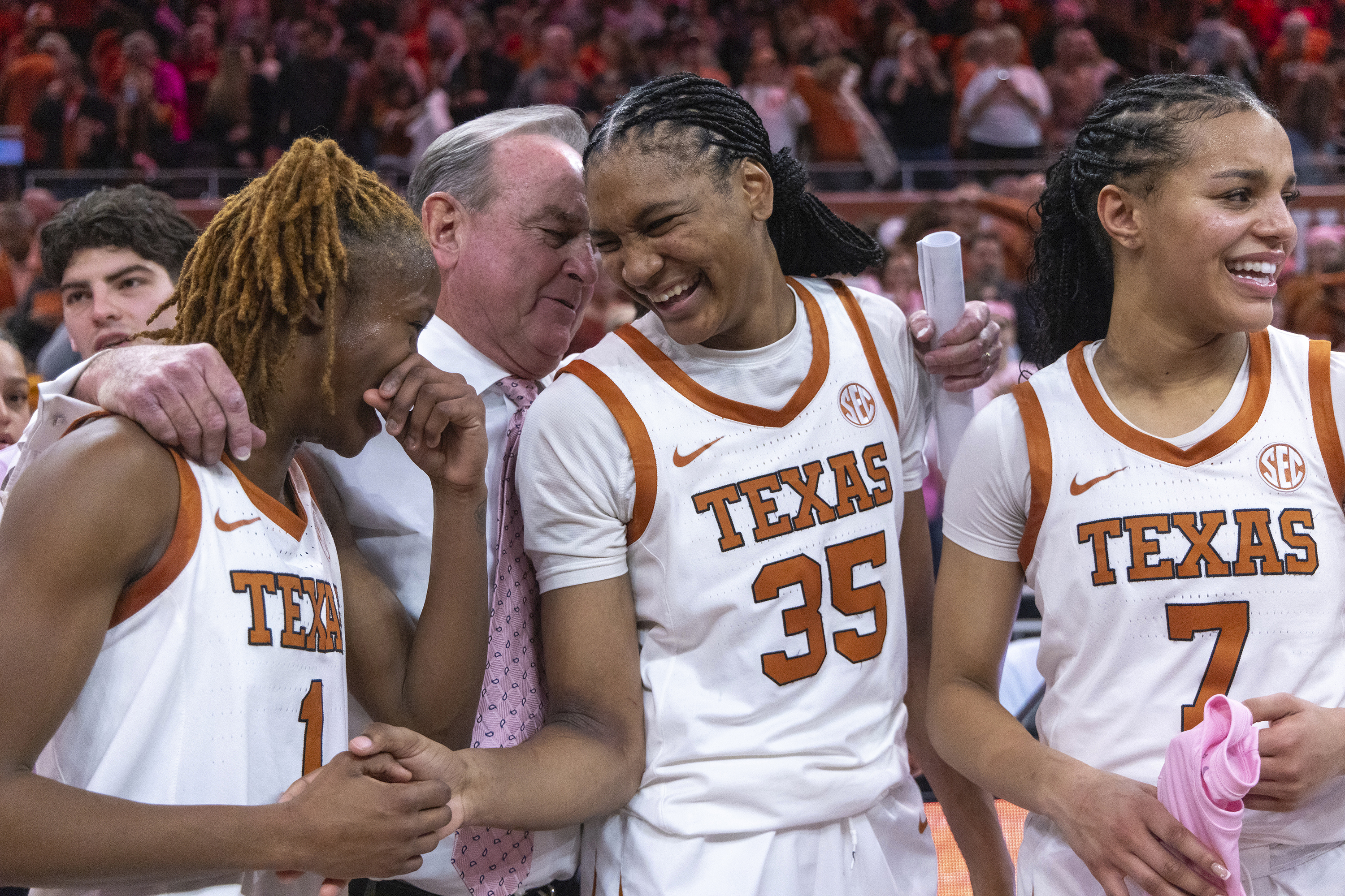 Texas guard Bryanna Preston (1), head coach Vic Schaefer, forward Madison Booker (35) and guard Jordan Lee (7) celebrate a win against LSU during an NCAA college basketball game in Austin, Texas, Sunday, Feb. 16, 2025.