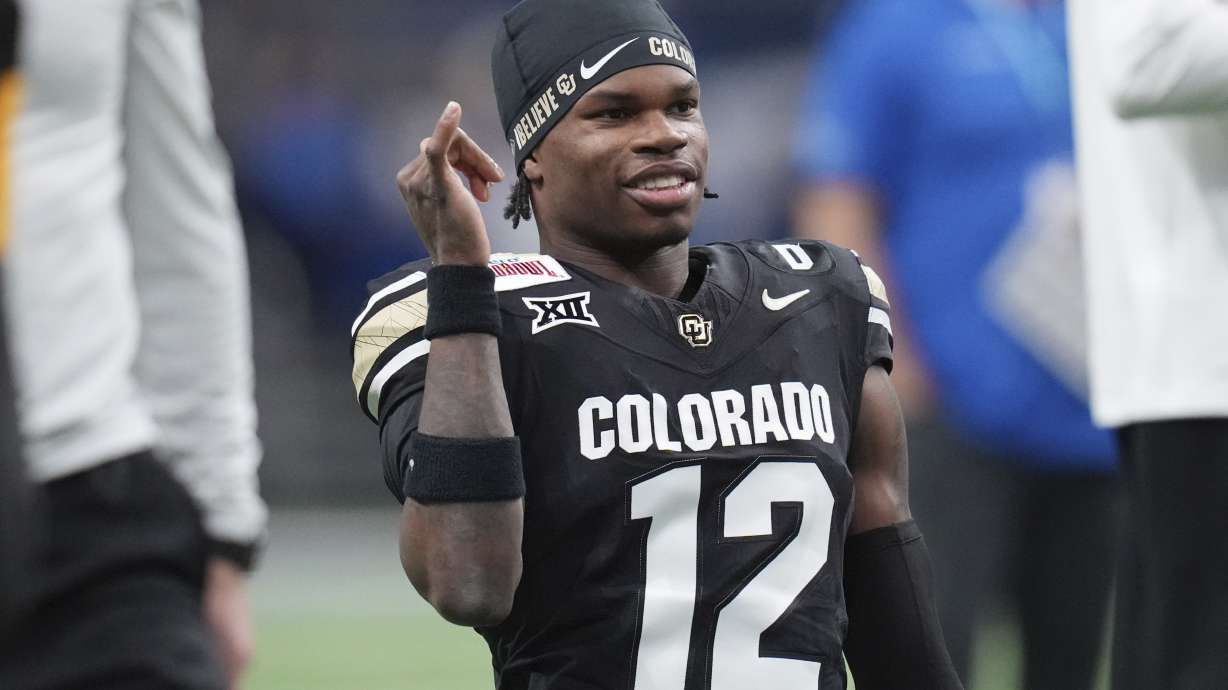 FILE - Colorado wide receiver Travis Hunter (12) warms up for the Alamo Bowl NCAA college football game against BYU, Dec. 28, 2024, in San Antonio.