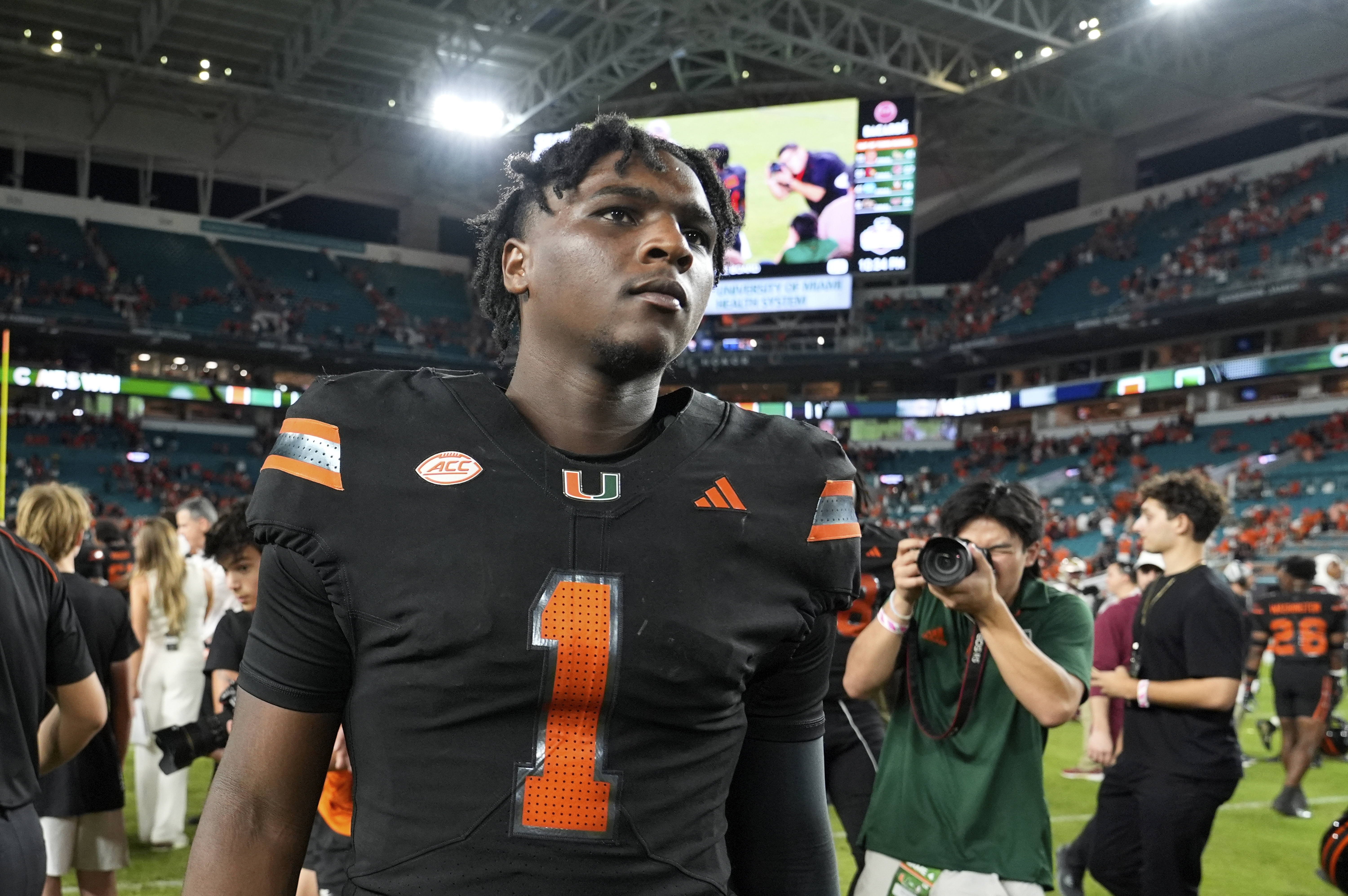 FILE - Miami quarterback Cam Ward (1) walks off the field after an NCAA college football game against Florida State, Oct. 26, 2024, in Miami Gardens, Fla. 