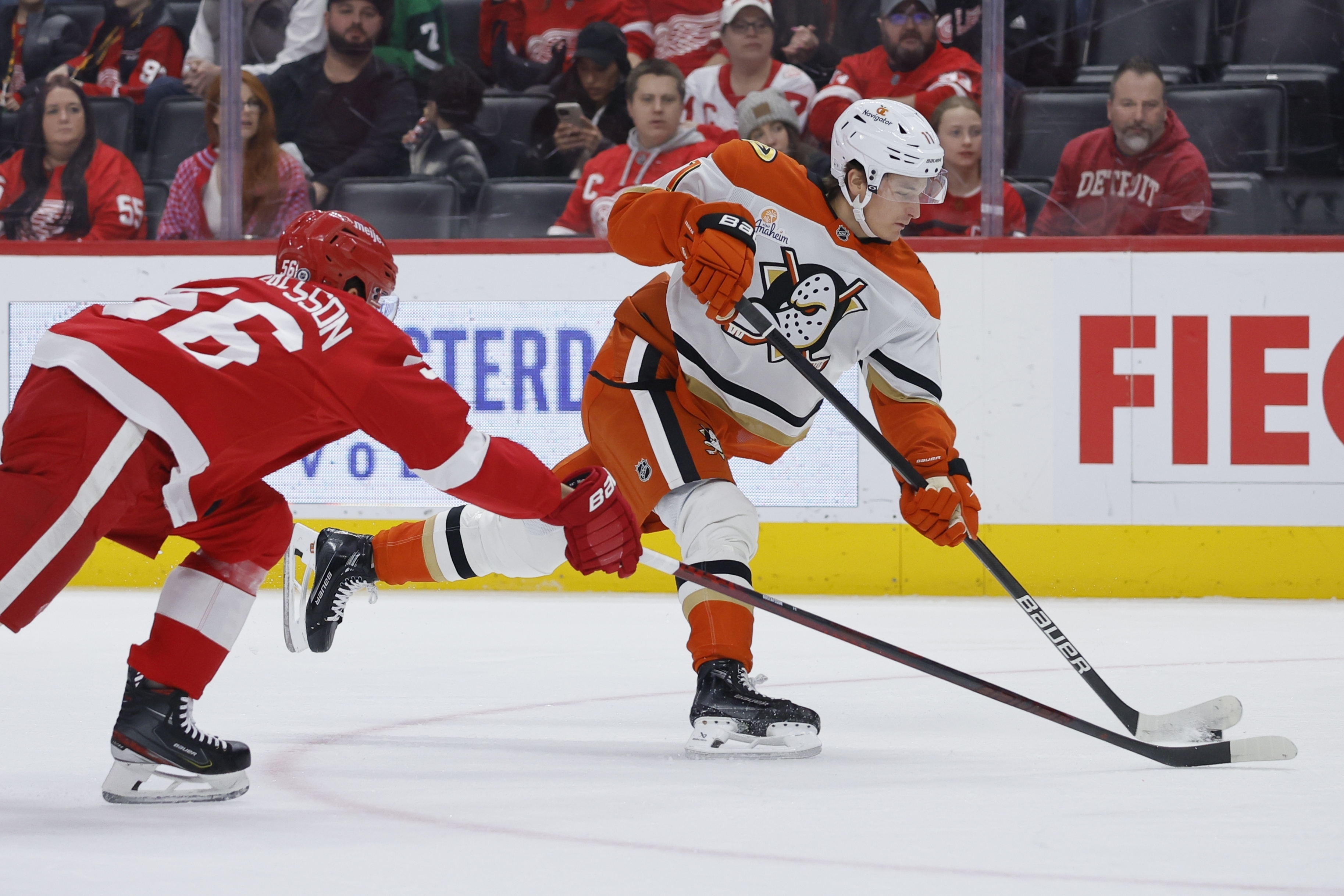 Anaheim Ducks center Trevor Zegras, right, shoots on goal against Detroit Red Wings defenseman Erik Gustafsson, left, during the first period of an NHL hockey game Sunday, Feb. 23, 2025, in Detroit. 