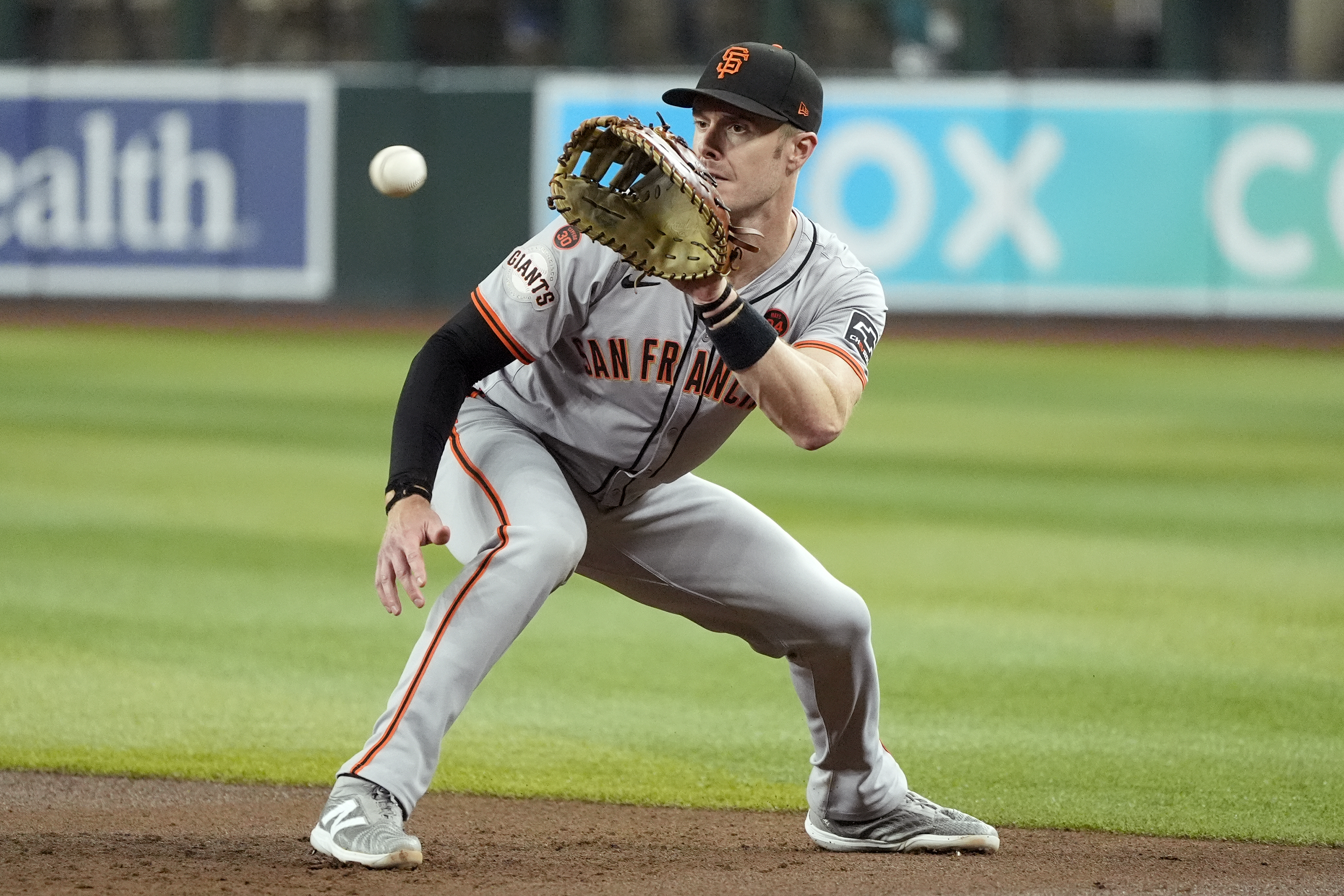 FILE - San Francisco Giants first baseman Mark Canha fields a ground ball hit by Arizona Diamondbacks' Jose Herrera before throwing to first base for an out during the third inning of a baseball game, Sept. 23, 2024, in Phoenix. 