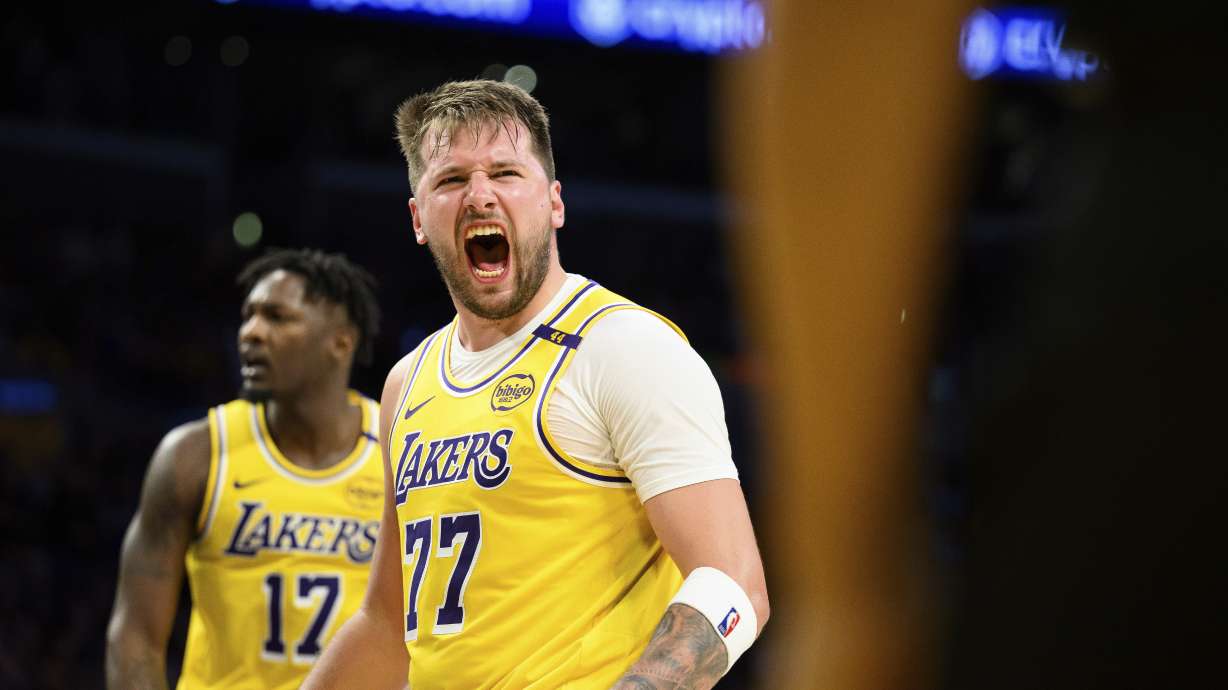 Los Angeles Lakers guard Luka Doncic (77) reacts after making a shot during the second half of an NBA basketball game against the Charlotte Hornets, Wednesday, Feb. 19, 2025, in Los Angeles.
