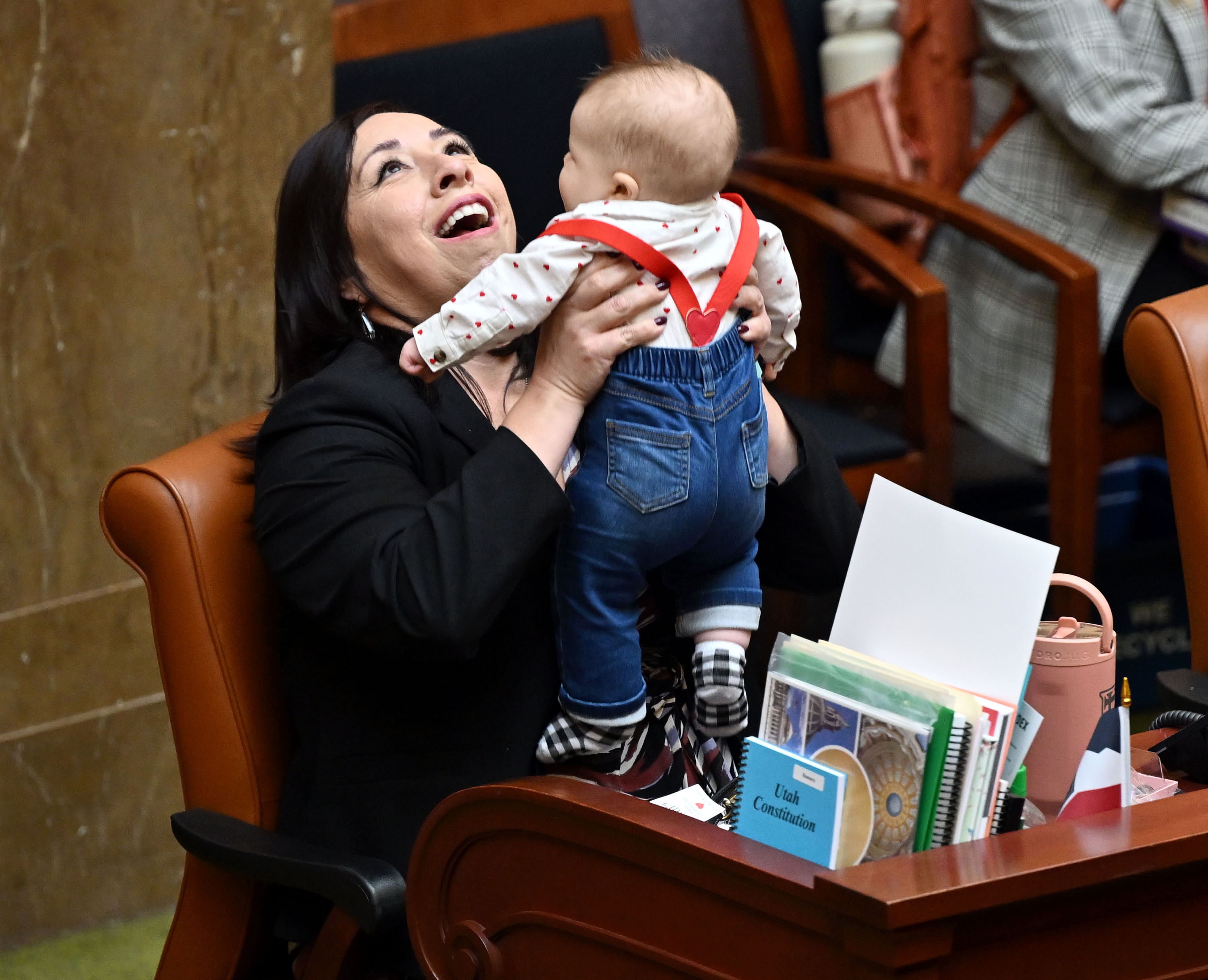 House Minority Leader Angela Romero, D-Salt Lake City, plays with 4-month-old Joey Matthews, who is the son of Rep. Ashlee Matthews, D-West Jordan, on Feb. 14. Joey gets passed around from staff to representative, whoever would like to hold him during floor time.