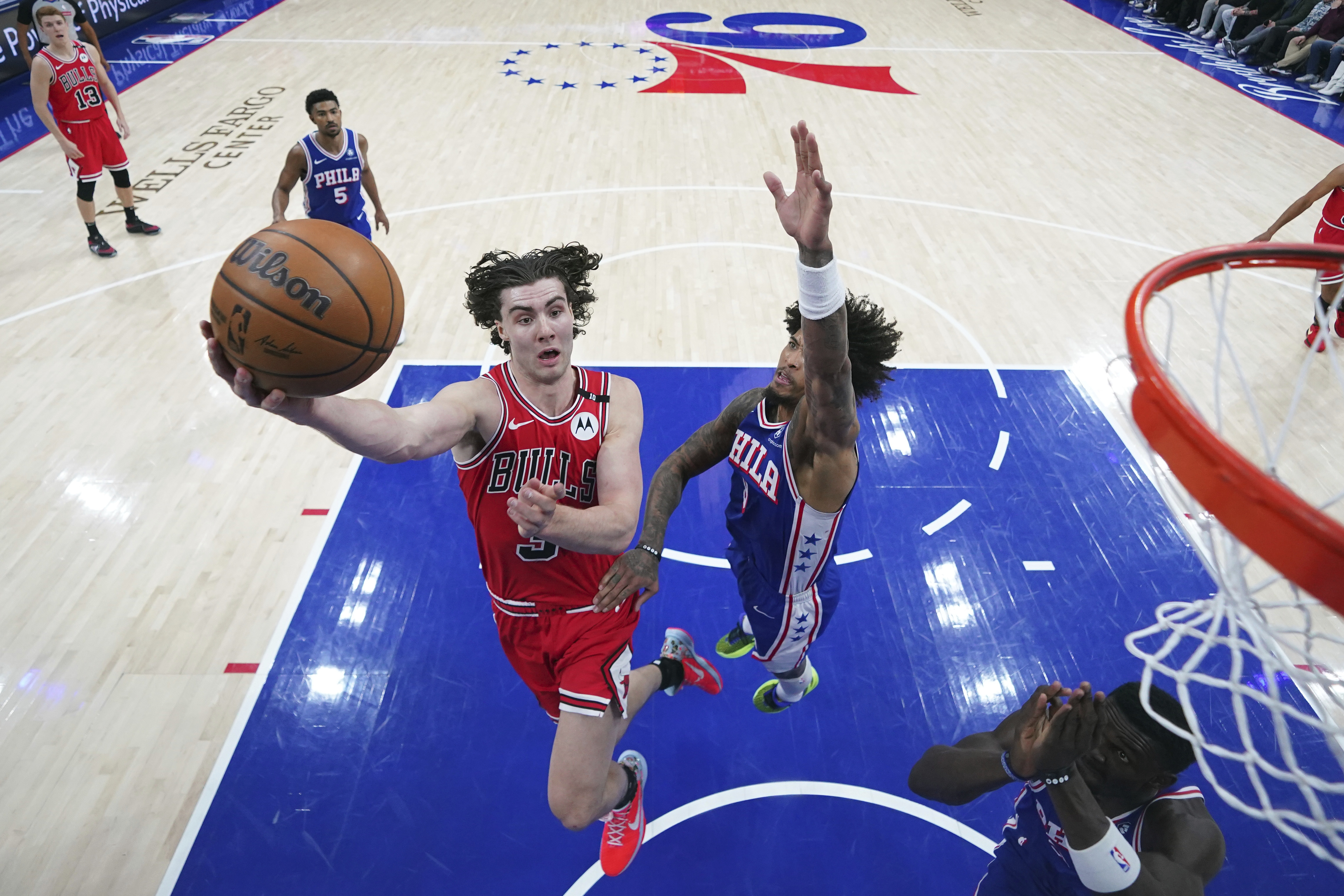 Chicago Bulls' Josh Giddey, left, goes up for a shot past Philadelphia 76ers' Kelly Oubre Jr. during the first half of an NBA basketball game Monday, Feb. 24, 2025, in Philadelphia. 