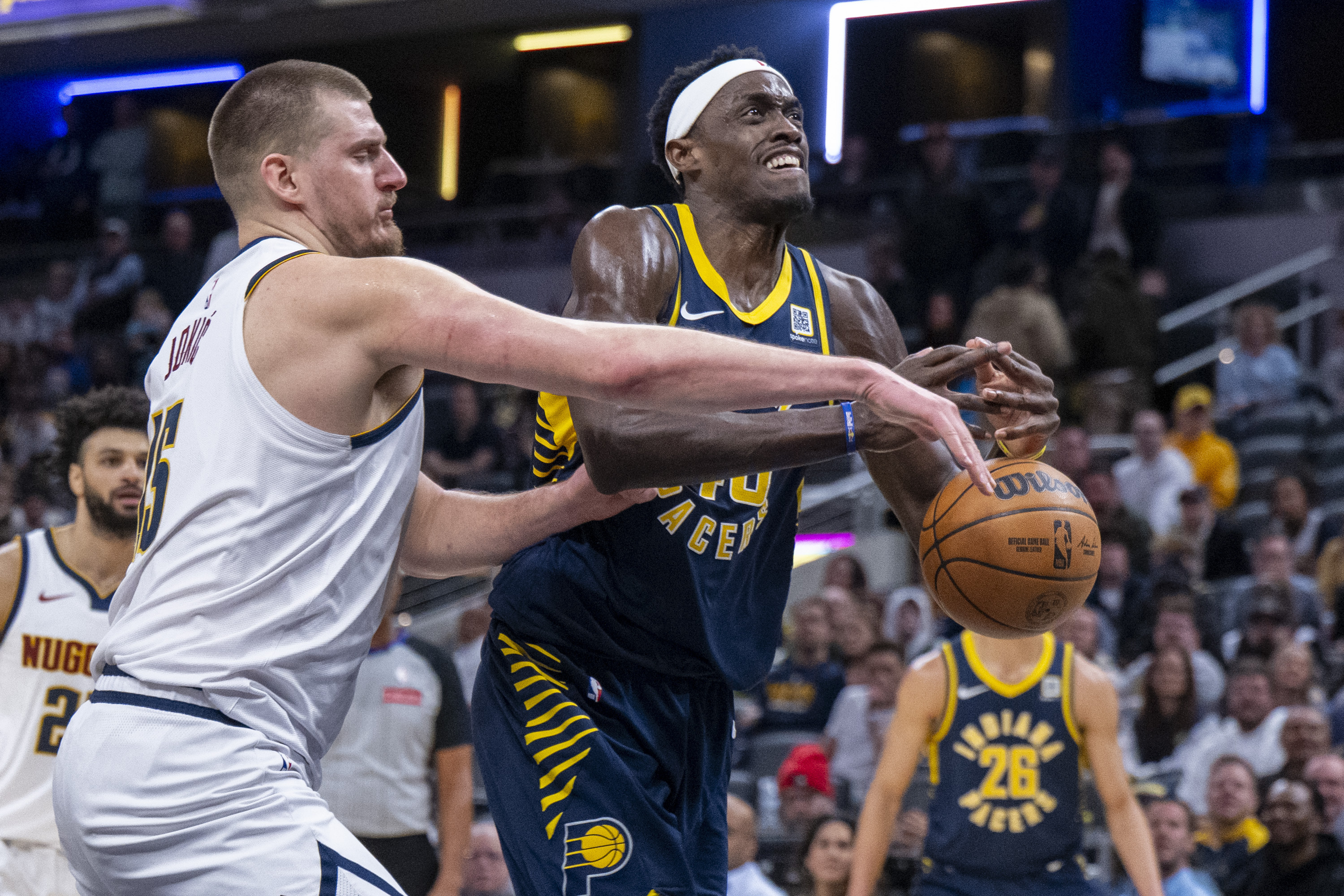 Denver Nuggets center Nikola Jokic, front left, strips the ball away from Indiana Pacers forward Pascal Siakam, front right, during the second half of an NBA basketball game in Indianapolis, Monday, Feb. 24, 2025. 