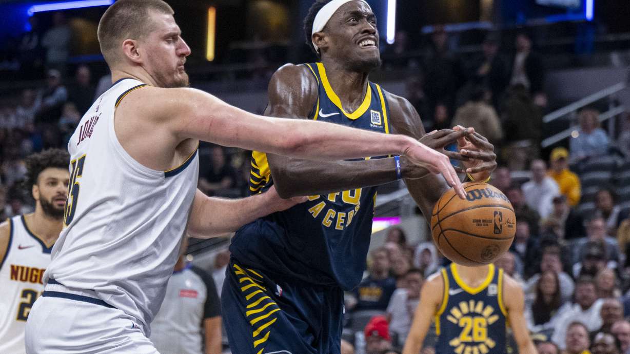 Denver Nuggets center Nikola Jokic, front left, strips the ball away from Indiana Pacers forward Pascal Siakam, front right, during the second half of an NBA basketball game in Indianapolis, Monday, Feb. 24, 2025.