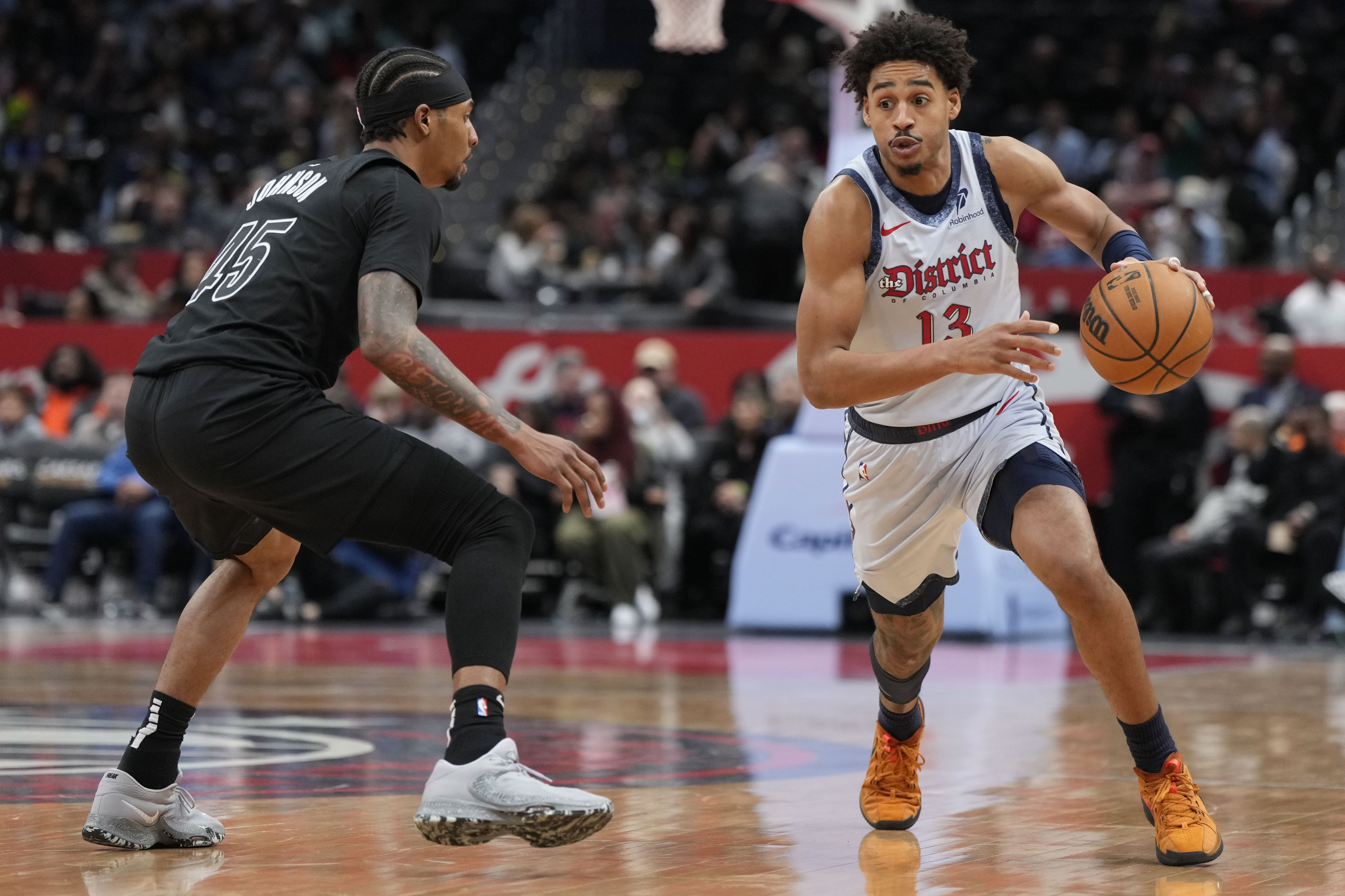 Washington Wizards guard Jordan Poole (13) dribbles downcourt as Brooklyn Nets guard Keon Johnson (45) defends during the first half of an NBA basketball game Monday, Feb. 24, 2025, in Washington. 