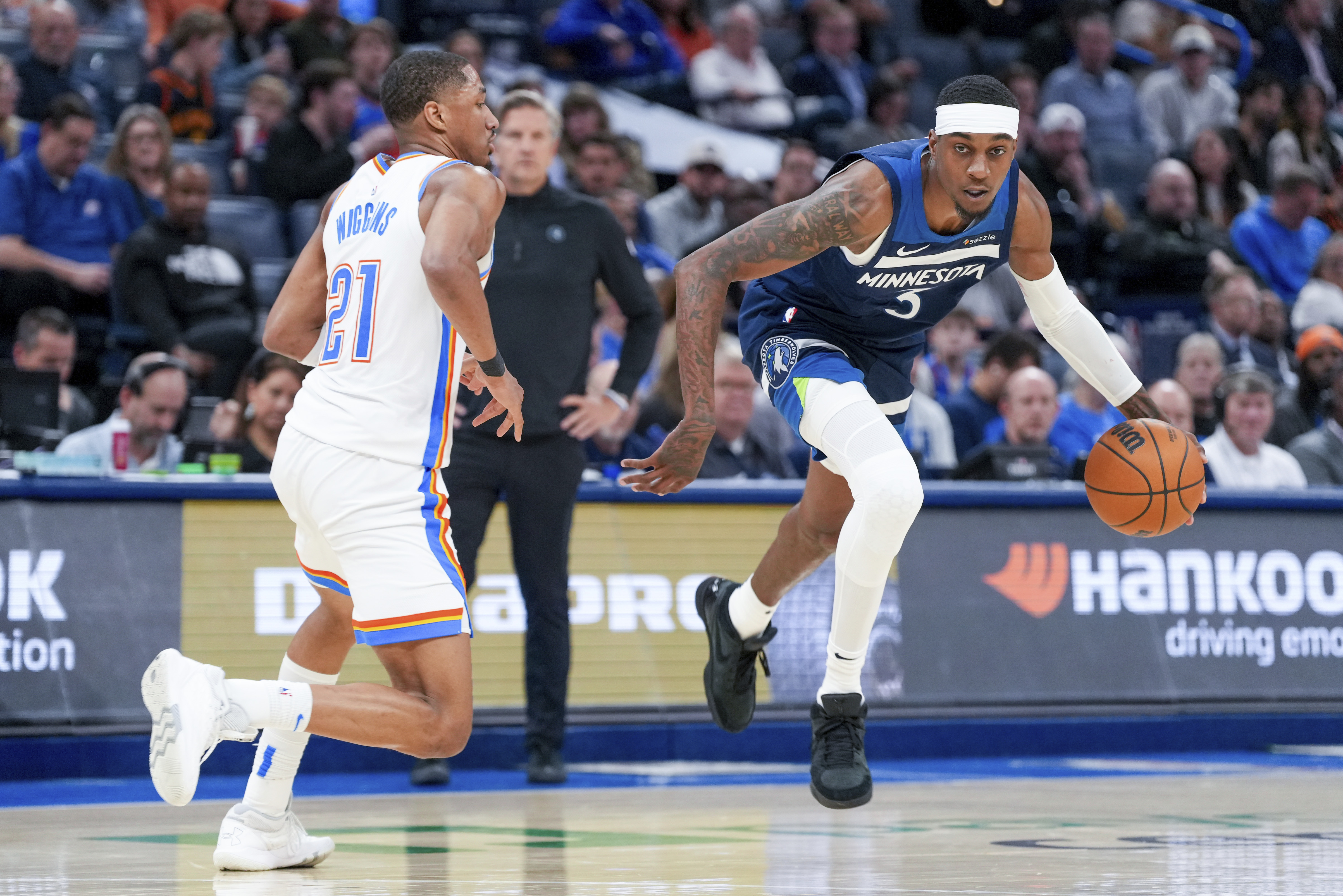 Minnesota Timberwolves forward Jaden McDaniels, right, pushes past Oklahoma City Thunder guard Aaron Wiggins, left, during the second half of an NBA basketball game, Monday, Feb. 24, 2025, in Oklahoma City. 