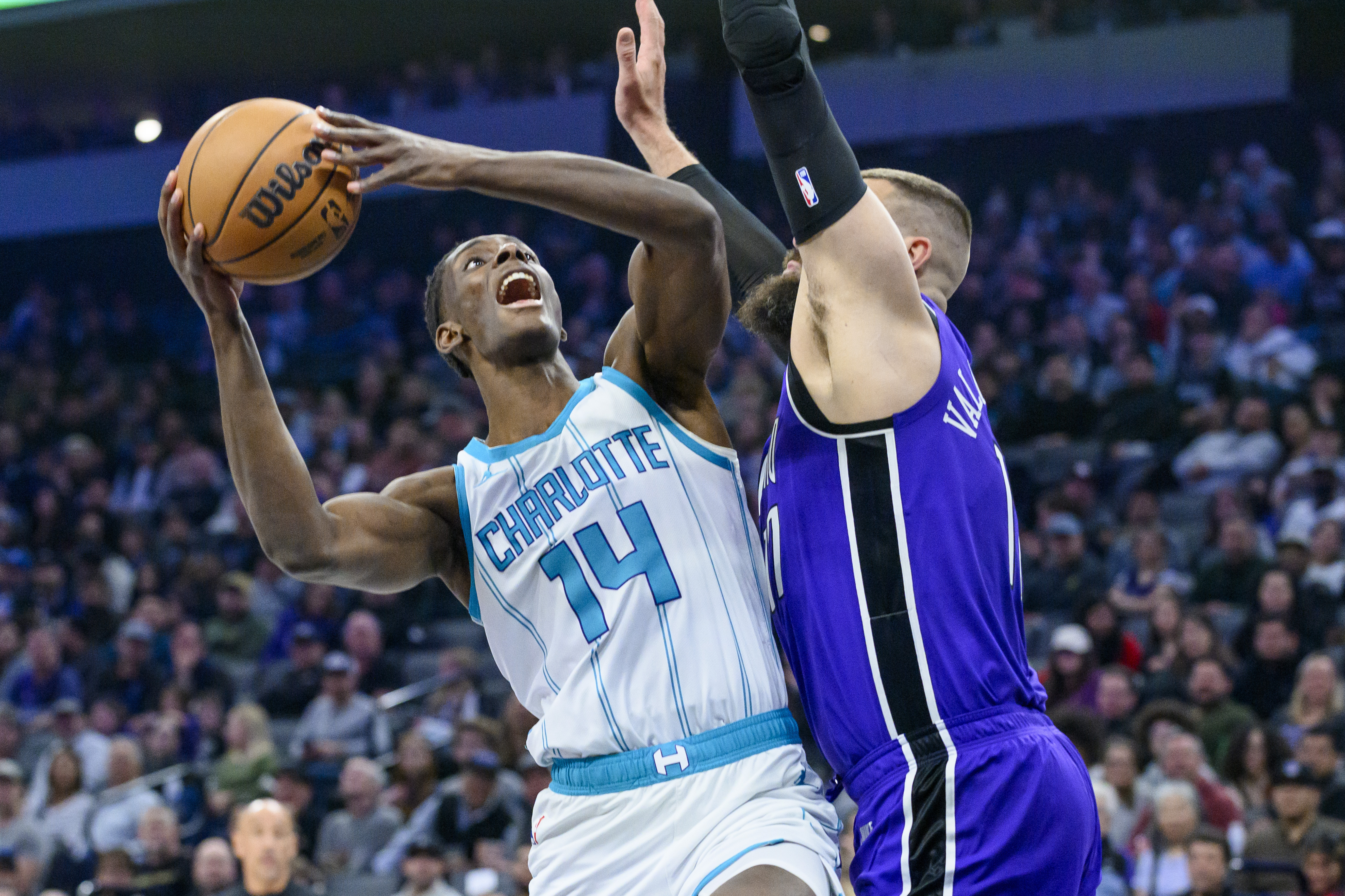 Charlotte Hornets forward Moussa Diabate (14) looks to shoot over Sacramento Kings center Jonas Valanciunas, right, during the first half of an NBA basketball game in Sacramento, Calif., Monday, Feb. 24, 2025. 