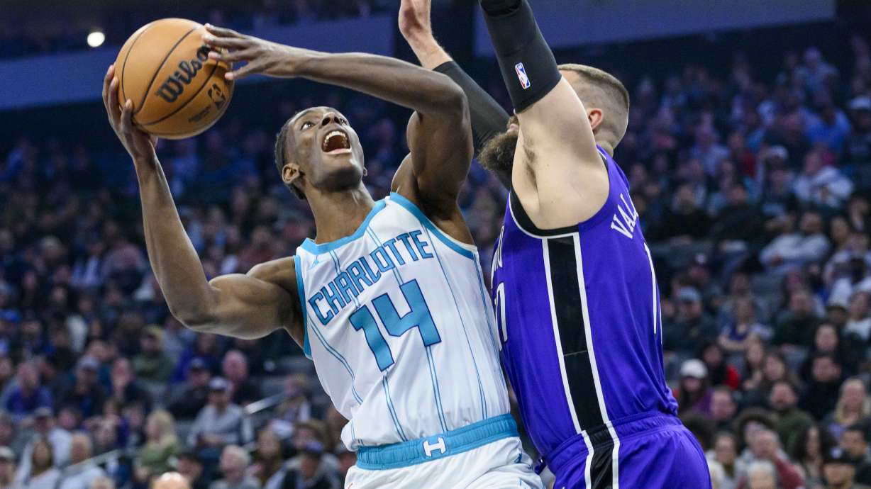 Charlotte Hornets forward Moussa Diabate (14) looks to shoot over Sacramento Kings center Jonas Valanciunas, right, during the first half of an NBA basketball game in Sacramento, Calif., Monday, Feb. 24, 2025.