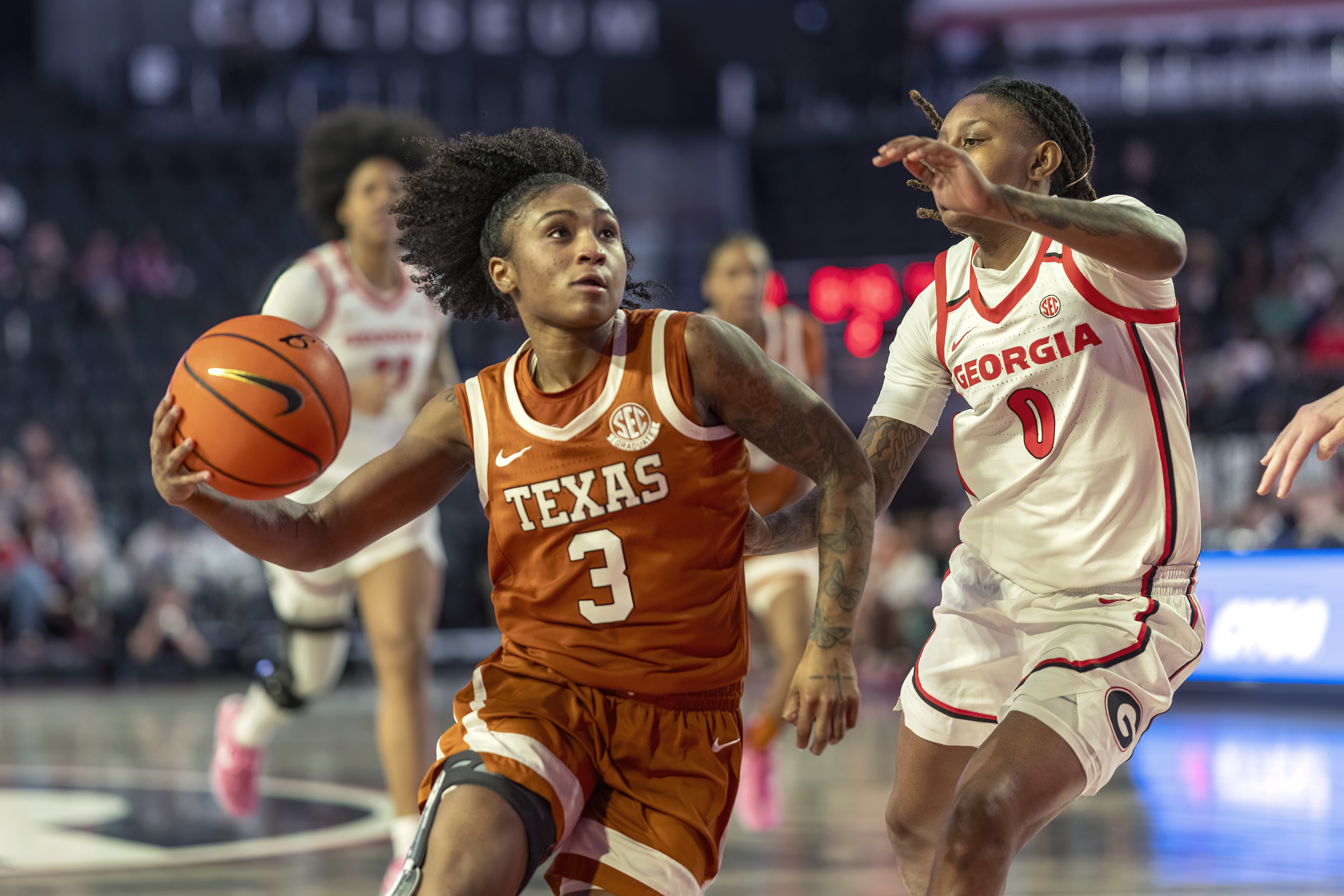 Texas guard Rori Harmon (3) drives the ball against Georgia guard Trinity Turner (0) during the first half of an NCAA college basketball game against Georgia, Monday, Feb. 24, 2025, in Athens, Ga. 